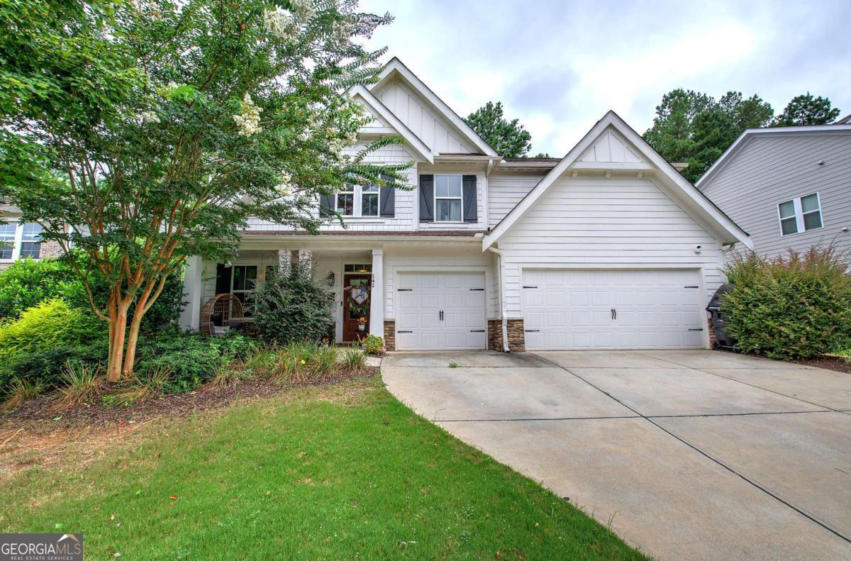 Welcome Home to 142 Floating Leaf Way! A stunning Craftsman Style Home in Highly Sought After Edenwood Community and North Paulding School District. A spacious, move-in-ready home offering the perfect blend of style, comfort, and functionality. Featuring 5 bedrooms, 2 1/2 baths, 2 bonus rooms with endless possibilities, and over 3,000 square feet of well-designed living space. The main level showcases a grand foyer, formal dining room with coffered ceilings, and a spacious fireside family room open to the chef's kitchen. The kitchen boasts granite countertops, stainless steel appliances, tile backsplash, a large island, and oversized pantry. The main level features two bonus rooms, ideal for an office, gym, gaming room...The possibilities are endless! Upstairs, retreat to the oversized owner's suite, spa-inspired bath with dual vanities, soaking tub, separate shower, and an expansive walk-in closet. Four additional secondary bedrooms, One full additional bath, and a laundry room with a mud sink. Each room featuring large walk in closets. The backyard is private and fenced, perfect for relaxing or entertaining on the extended patio. Enjoy the rocking-chair front porch and beautifully maintained exterior. Additional private fenced area for the dogs to go and explore that is separate from the families outdoor play area. 3 Car Garage! Don't miss out on this gorgeous home!