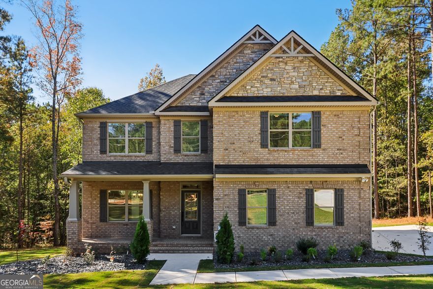 Another quality built home by Sun Rise Brothers Properties LLC. The Oaklan Plan offering 5 bedrooms and 3 bathrooms.  Owners suite is located upstairs and offers plenty of space for a sitting area, workout area or nursey. Three secondary bedrooms and an additional bathroom are also upstairs.  One bedroom on the main floor with bathroom access.  Open concept with chef style kitchen with soft close cabinets/drawers and quartz counter tops.  Spacious great room with fireplace and an over sized formal dining room.  Step out on the covered deck and enjoy the cool breeze from the ceiling fan while overlooking the large private back yard.  Take a stroll on the trail that leads down to the creek for a relaxing afternoon.  Unfinished basement is the perfect canvas for your vision!  Close to all McDonough has to offer and located in the Ola School District.  Call agent for builder incentive details.