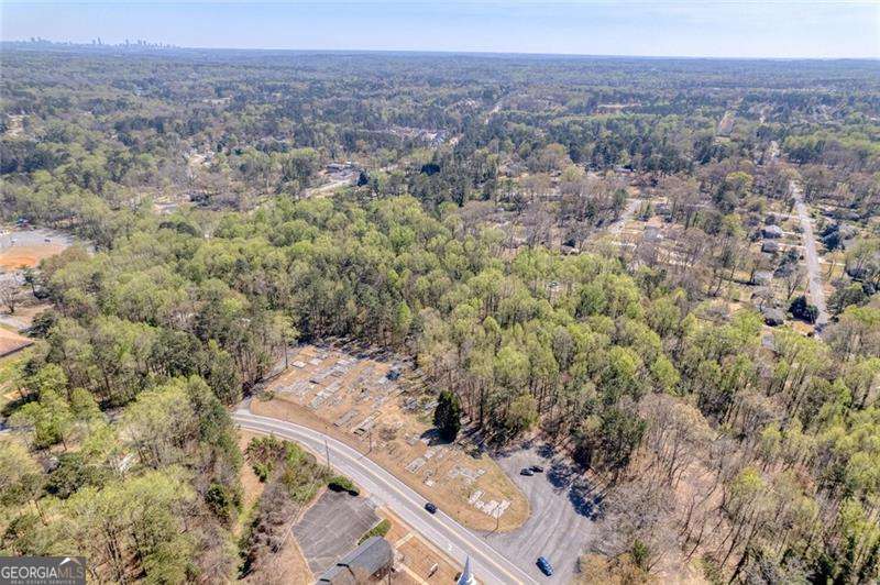 9.5 Total Residential Acres in Marietta Ga, this sale includes 4 lots that total 9.5 acres, lots included are parcel number 19070300580 with 7.1 acres, 959 Old Milford Church Road Parcel number 19070300310 with 1.1 acres, 929 Old Milford church road parcel number 19070300450 with .50 acres, and 969 Old Milford Church Road parcel number 19070300440 with .80 acres. Property is near the corner of Hicks Road, Smyrna Powder Springs Road and Milford Church Road, across from Milford Baptist Church and walking distance to Birney Elementary School. Electrical Power, Cobb County water service, and Natural Gas from Austell Gas, on site at 959 Old Milford Church and 969 Old Milford church, the 7.12 parcel has a sewer easement on the property. Only 6.9 miles to I-75 and 8 miles to the Braves stadium and The Battery. Two homes and a barn on the property which could be renovated or torn down. Property is heavily covered with ready to harvest hardwoods and has a creek running through the property in two locations.