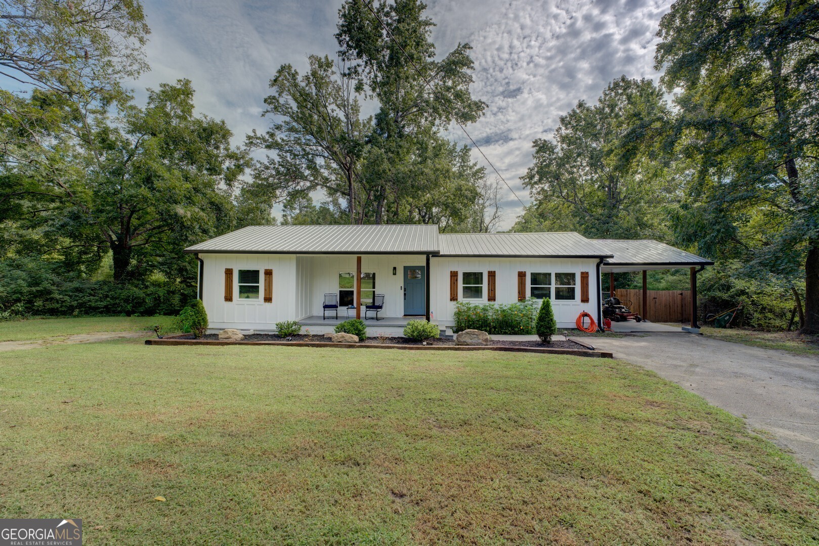 Welcome to this charming 3 bedroom, 2 bathroom ranch in the heart of Monroe! Perfectly located close to town, you can easily access shopping, dining & more with just a brisk walk or golf cart ride. Sitting on 1.14 acres, this home offers plenty of space, privacy & charm. The split bedroom plan features custom finishes throughout, with recent updates that make it move-in ready. Enjoy the outdoors on the spacious back deck overlooking a large, private backyard- partially fenced & perfect for your pets! With an attached carport and plenty of parking, this property combines convenience, comfort & room to spread out & entertain! No HOA! Make an appointment today to view this beautiful home!