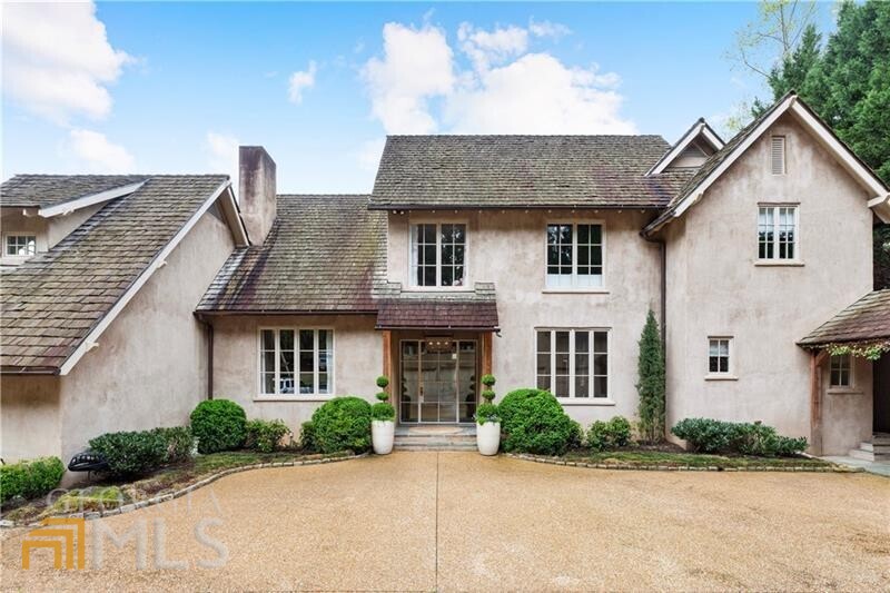 Stunning home deigned by Keith Summerour and built by Benecki Homes with salt water Pebble Tec pool, situated on a private 1.5 acre lot. Gorgeous renovation that includes Design Galleria kitchen with waterfall marble island, 2 dishwashers, walk in pantry, wood beamed ceiling. Mudroom with 2 sets of washer/dryers, desk area. Oversized family room with steel beams, vaulted ceiling, limestone fireplace. Additional features include reclaimed wood floors, steel windows and doors, venetian plaster walls, cedar shake roof. Primary suite on main with Atlanta Homes and Lifestyle "bathroom of the year" with iron windows that overlook gardens and a pond, steam shower, 2 story walk in closets. 3 en-suite bedrooms upstairs with loft space. Terrace level with huge flex area, wine cellar, gym, pool bath, guest bed/bath. 4 car garage with guest suite with bed/bath, living room. Gated and private, with views of lakes. New Sonos system hardwired throughout, full house water filtration system. Minutes to area private schools, Chastain Park. Truly a special one of a kind home!