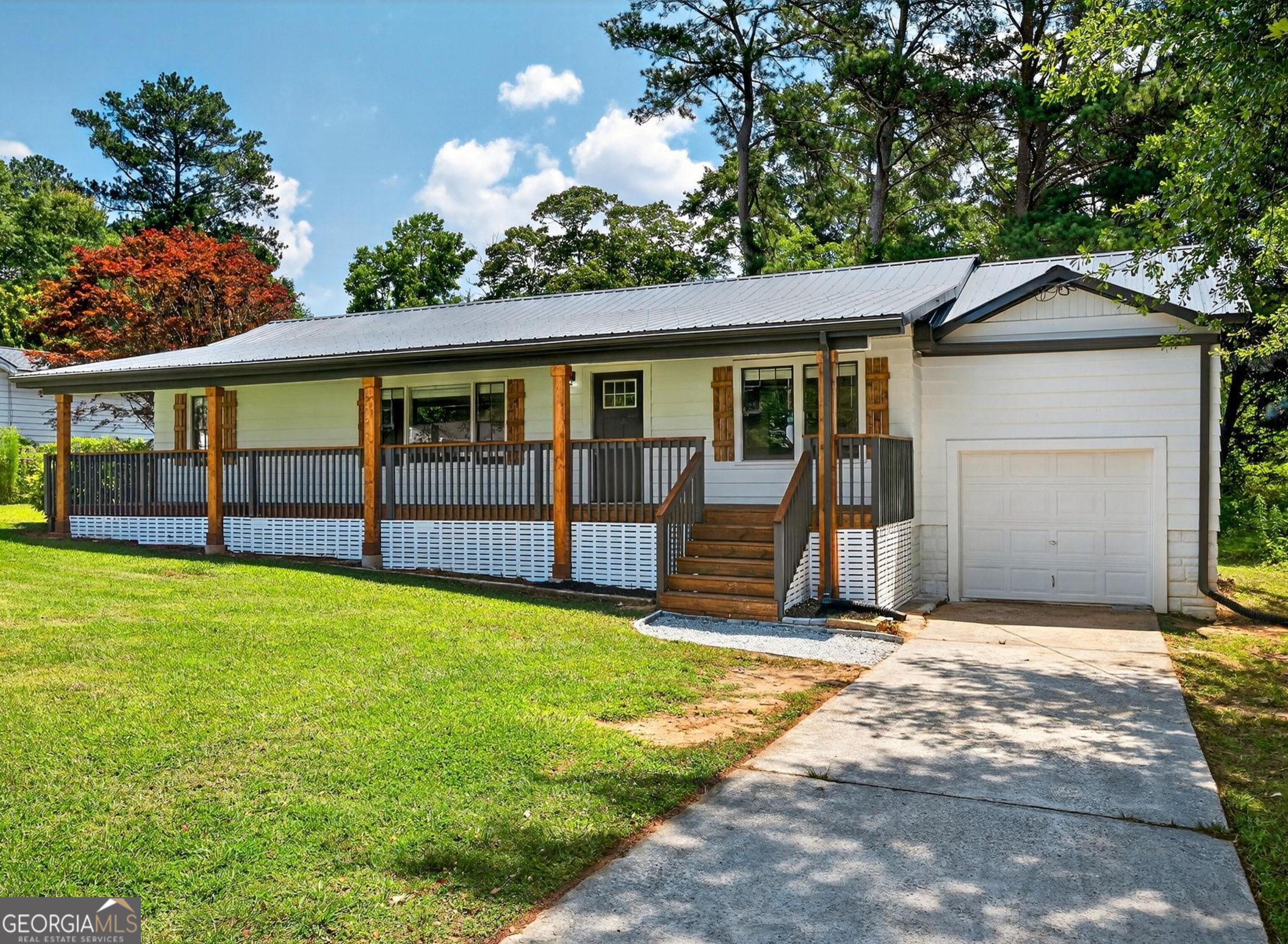 Beautifully renovated farmhouse on a nice flat lot in Mableton! NEW interior and exterior paint, NEW refinished hardwoods throughout, NEW cabinets AND quartz countertops in the kitchen and bathrooms, NEW light fixtures and blinds throughout - the list goes on! This meticulously renovated home on a large level lot offers 3 bedrooms, 2 full bathrooms, and one car garage. If you don't immediately fall in love with the huge covered front porch, you most certainly will when you enter into the large living room that looks directly into the brand new kitchen. The kitchen includes tons of cabinet space, brand new quartz countertops, and stainless steel appliances. Off of the kitchen is the dining room, and access to the laundry room and garage. Down the hall from the living room is a cozy sunroom with wall-to-wall windows. Moving past the living room you'll find 2 generously sized additional bedrooms with refinished hardwoods and new paint, and a large full hall bathroom with updated cabinets and quartz countertops, and new paint throughout. The master has new paint and refinished hardwoods, and a beautifully renovated en-suite bathroom that features a new cabinet and quartz countertops, and a new walk-in shower! This beautifully updated home has an amazing backyard making for a serene and private space to enjoy with family and friends. All of this less than 25 minutes to downtown Atlanta, 20 minutes to The Battery, 15 minutes to downtown Smyrna, and 25 minutes to the airport. Don't wait, come and see this Mableton beauty today!