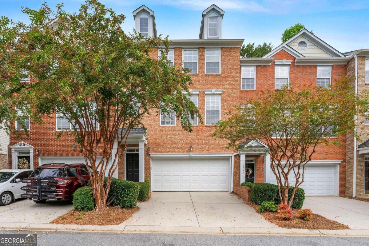 Incredible location! Atlanta address with Cobb County taxes! Wonderful brick townhome in a gated community backing up to nature trails that take you to the Chattahoochee River. The townhome is one of the largest in the community with 5 bedrooms and 3.5 bathrooms. There are 3 bedrooms and two bathrooms upstairs and 2 bedrooms with a full bathrooms downstairs creating a perfect space for in-laws or a teen suite! The main level has an incredible open floor plan with a large kitchen with tons of natural light and tons of cabinets for storage. The huge kitchen looks out to the dining room and the living room. Amazing outdoor living space with a full deck and patio to enjoy the private backyard and view. The community has open space, a clubhouse perfect for larger events, onsite fitness center, and amazing pool! Super close to trails, shopping, amazing restaurants, Truist Park, and more!