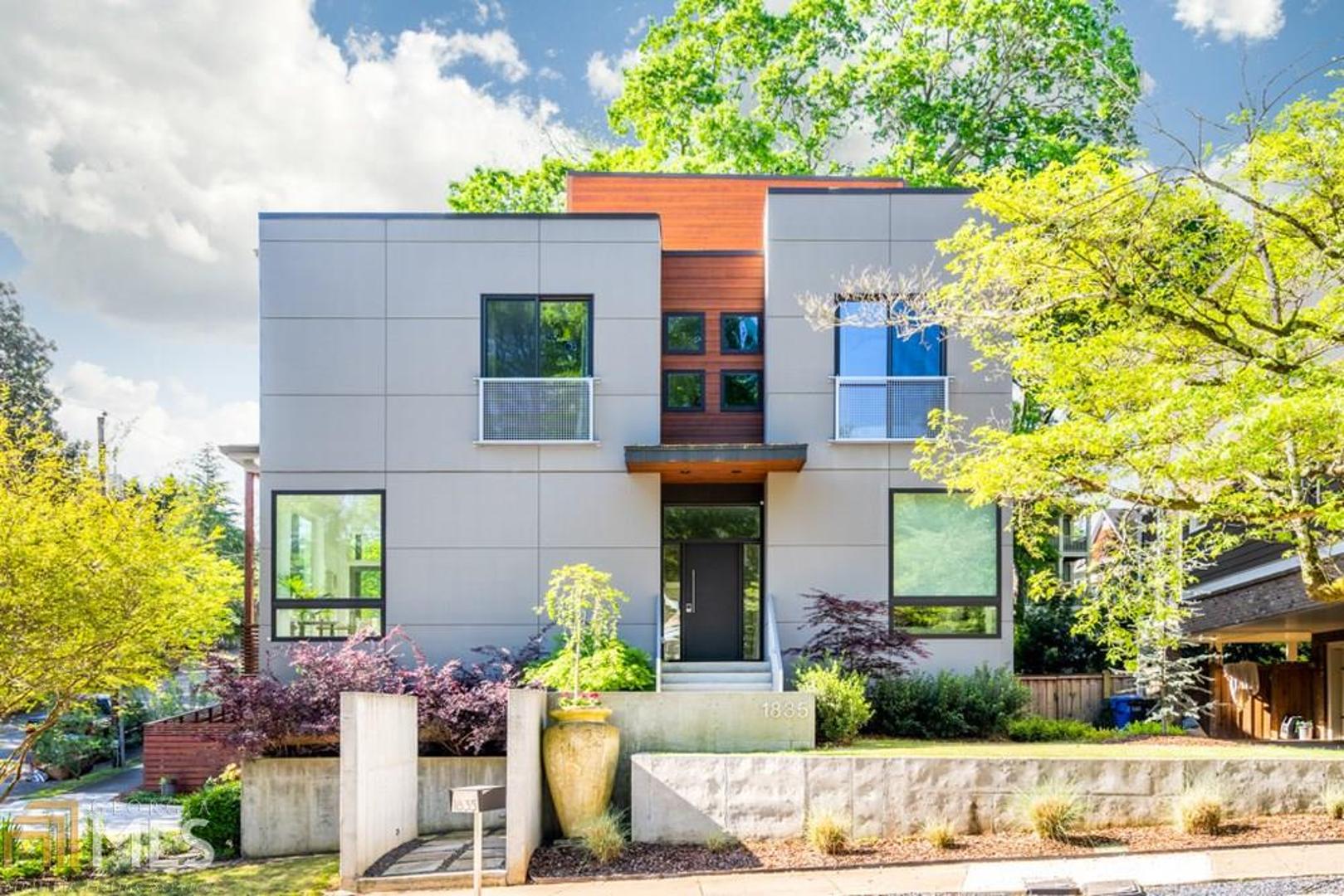 Pristine modern home lives comfortably with warm inviting spaces inside and out. Thoughtfully designed to bring Atlanta's beautiful outdoors inside. Disappearing glass kitchen wall provides al fresco dining and entertainment with a turn of the latch! Large windows and doors stream abundant natural light and fresh air throughout the home. Fenced rear yard is a gardeners dream.