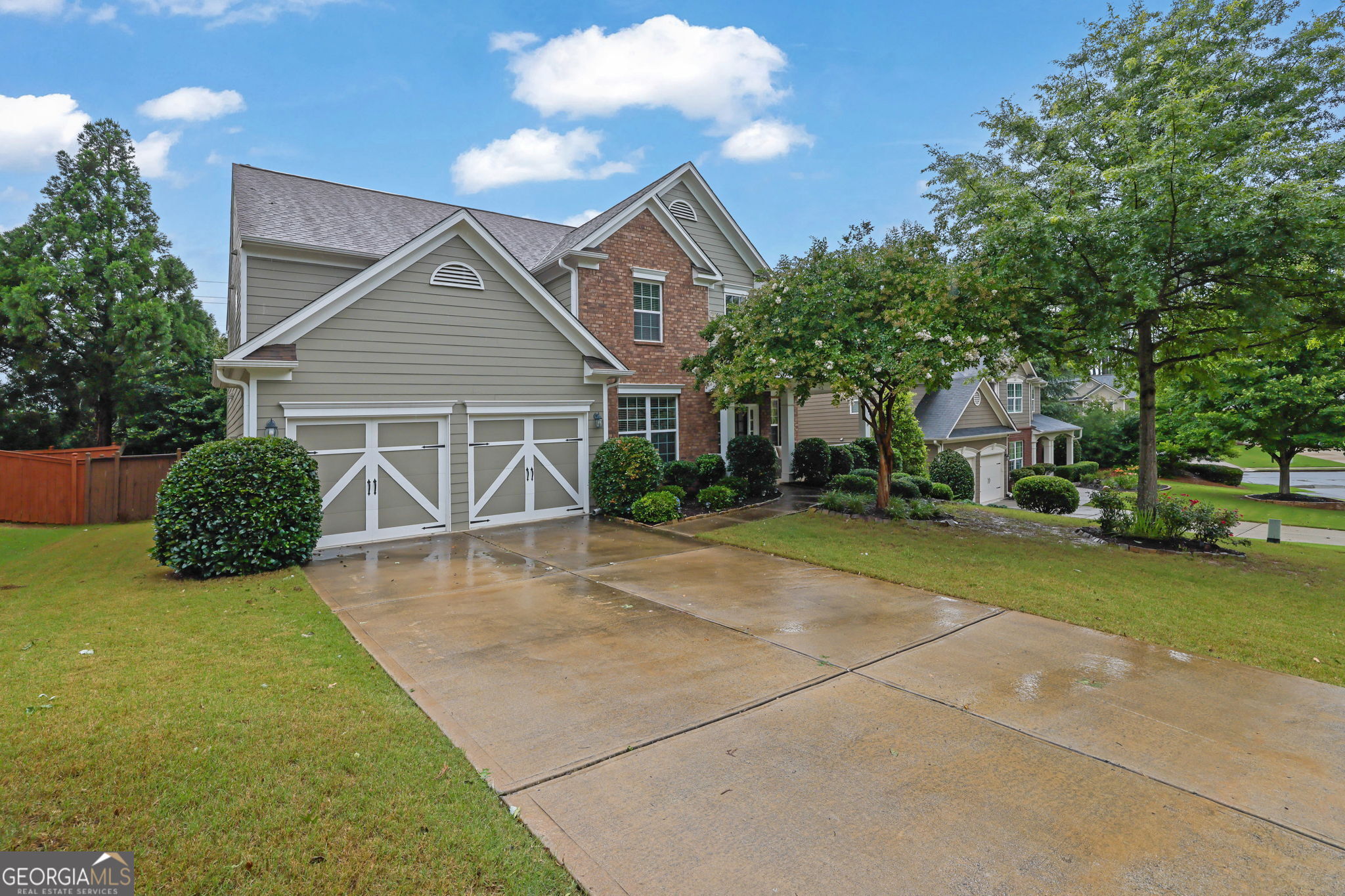 Tucked just off Highway 92 in the beautifully maintained neighborhood of Madison Falls, this Cherokee County gem offers quick access to East Cobb, Roswell, I-575, GA-400, and the Peach Pass lanes. Within minutes of several highly rated schools, community parks, places of worship, nature trails, and fitness clubs, this five-bedroom, three-bath home features a dual fireside sunroom located just off the open, naturally lit, soaring great room. The open kitchen includes a walk-in pantry, small island, and breakfast area that flows directly into the heart of the home, all functionally yet seamlessly connected to the large open formal dining room. Directly across from the dining room, you'll find a private office or study with custom built-in shelving. When touring, be mindful not to overlook the private guest bedroom on the main level and the full bathroom, which offers guests a completely private space. Upstairs, the oversized primary bedroom includes a highly functional custom closet and an open area large enough to serve as a sitting space, workspace, or nursery. With high ceilings and generously sized rooms throughout, this home feels much larger in person than photos or measurements could capture. Within the last two years, the exterior has been freshly painted and the water heater replaced, and the roof is less than three years old. The HVAC has been regularly serviced, and the low-maintenance yard offers a great canvas for your personal touches. A short drive from the entrance puts you at your front door, and a short walk from the home leads to the community pool and playground. With an abundance of nearby shopping, dining, and grocery options-including the Outlet Shoppes and most major retailers within a five-mile radius-running daily errands or planning evenings out in this special part of Woodstock is even more convenient than one might imagine.