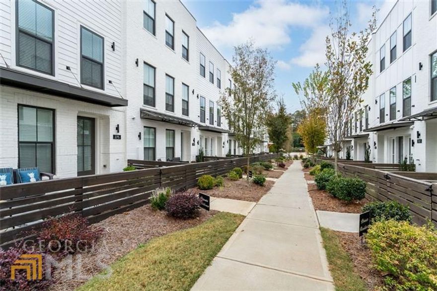 This place is Spectacular & Like BRAND New! WALK to Downtown and all things Shopping/Everything!Walk or take your golf cart and enjoy all that downtown Woodstock has to offer! Shopping, restaurants, GreenPrint trails, summer concerts, farmers market and the list goes on! Combine all of this with being less than two miles from the Outlet Shoppes and  Parks! 3 Bedrooms 3.5 Bathrooms. Open concept kitchen with designer cabinets, stainless appliances and over sized island. 10ft Ceilings on Main! High end hardwood floors. Master Spa like shower with frameless door and beautiful tile surround. Private professionally landscaped fenced in courtyard. Stunning unique exteriors feature timeless painted brick. Location, location, location! Only 2 minutes to 575 AND within walking distance to Downtown Woodstock Enjoy your own outdoor space with a huge deck for entertaining and a private fenced front courtyard ideal for pets. HOA maintains lawns, landscaping, termite control, staining and painting exterior, community fire pit, sidewalks and doggie stations. Truly turn-key living and a MUST SEE