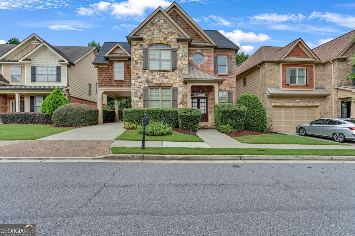 Discover exceptional, maintenance-free living in this stunning home, nestled within a secure gated community, offering privacy, style, and convenience at every turn. Located in the highly sought-after Peachtree Ridge school cluster, this residence boasts a fully finished basement complete with a second kitchen-ideal for multi-generational living, entertaining, or creating the ultimate guest retreat. Enjoy the ease of a covered carport with direct access to the main kitchen, making unloading groceries or hosting gatherings effortless. Inside, you'll find a sleek and modern kitchen outfitted with stainless steel appliances, perfect for the home chef. The master suite is a true showstopper, featuring a one-of-a-kind bathroom design that blends elegance and personality for a spa-like experience. Whether you're relaxing indoors or enjoying the peace of a gated neighborhood, this home offers the perfect blend of functionality and flair. Don't miss your chance to own this uniquely versatile property. Schedule a showing today!!!