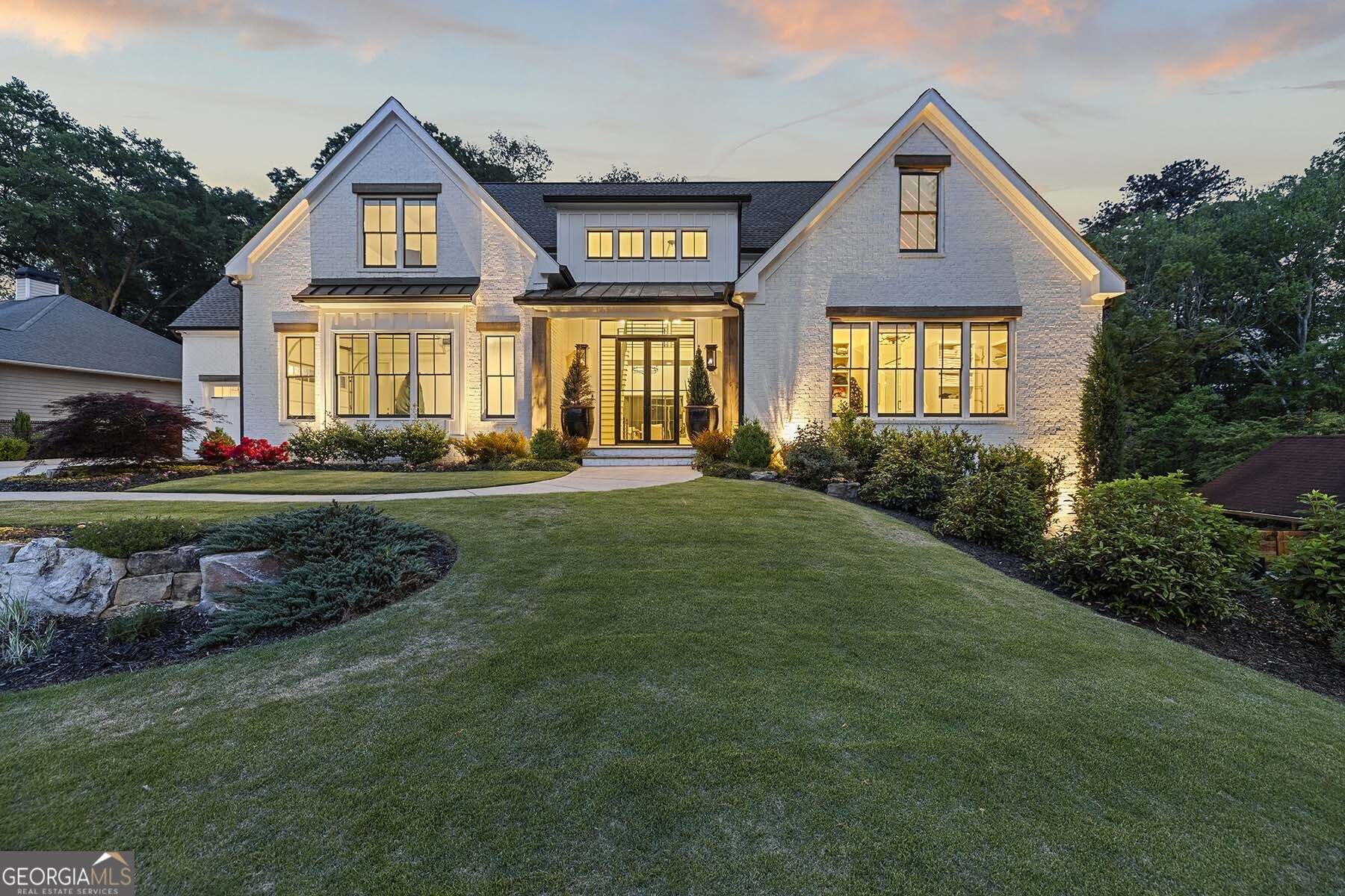 Welcome to an unparalleled retreat in the heart of Downtown Alpharetta - a masterpiece of modern living and timeless design. This like-new custom-built home sits majestically on an oversized lot, offering an extraordinary blend of luxury, style, and functionality. A grand entrance awaits you through 10-ft double metal doors on the covered bluestone porch, adorned with gas lanterns. The 2-story foyer introduces an atmosphere of sophistication, complemented by a custom metal railing staircase, exquisite metal lighting, and designer hardwood floors. The main level is designed for both entertaining and everyday living. The vaulted family room, with its gas fireplace, seamlessly connects to the Chef's kitchen. Revel in the culinary delights with a massive island, 48" gas range and refrigerator, custom vent hood, and floating shelves that harmonize with beautiful beams. The main level also hosts the primary suite, featuring a detailed brick accent wall. The spa-like bathroom boasts double vanities, custom cabinets, an oversized shower, and a soaking tub. A large custom walk-in closet finishes out this suite. Outside, you will discover two covered living spaces - one equipped with a kitchen, gas grill, and smoker station, while the main lanai offers a wood-burning fireplace and a TV mount for enchanting evening events. The walkout main level backyard is a haven of relaxation and recreation, featuring a heated pebble-tec, saltwater pool & hot tub, surrounded by split rail fencing and lush landscaping on one of the largest lots in the community. The terrace level is ready for entertaining with stained concrete floors, custom wood plank & brick walls, a media room, billiard room, wet bar, exercise room, bedroom & full bath, along with unfinished storage. This residence offers one of the best locations, providing easy access to fabulous Downtown Alpharetta through a city cut-through at the end of Upshaw/Meadow Drive. Schedule your private tour and make this masterpiece your forever home!