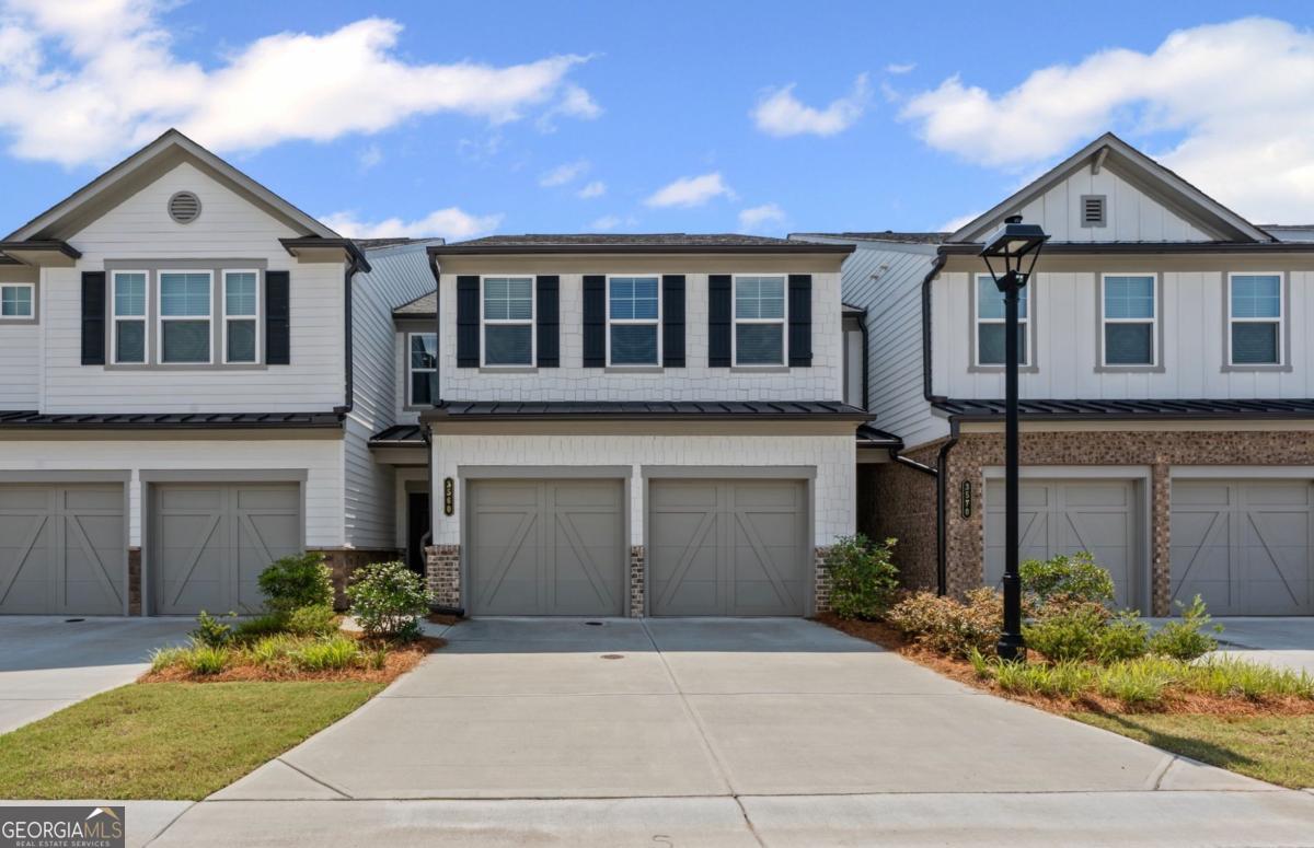 Welcome to a stunning lake view townhouse in the most sought after neighborhood of Encore in beautiful Duluth! This gorgeous two years old townhouse offers 3 bedrooms, a loft and 2.5 bathrooms. The bright and open townhouse is great for modern living with HOA maintaining the outdoors. Main level boasts a living room that over looks a serene lake making it a great spot for entertaining or unwinding at night. Modern kitchen features luxurious quartz countertops, a huge island, ample space in cabinets and top of the line steel appliances with a brand new refrigerator. Upstairs is an open loft to make it a small library or play room for the little ones. There are two bedrooms upstairs with abundance of light coming in. Primary bedroom, a true retreat has multiple windows and attached bathroom with double vanities, a seamless glass shower and a huge closet. Encore offers top notch amenities of 50 acres of green space, tennis courts, cabana, swimming pool, lakes and well lit streets. Scenic pathways to Cauley Creek park, Rogers Bridge Tubing launch ramp and Chattahoochee dog park makes it a great place for active lifestyles. Enjoy the peaceful living with minutes drive to versatile restaurants, shopping and easy access to highways. And let's not forget the beautiful Chattahoochee river near by making it an exceptional location. Don't miss this opportunity to call this gorgeous townhouse your new home in 146 acre master planned community!