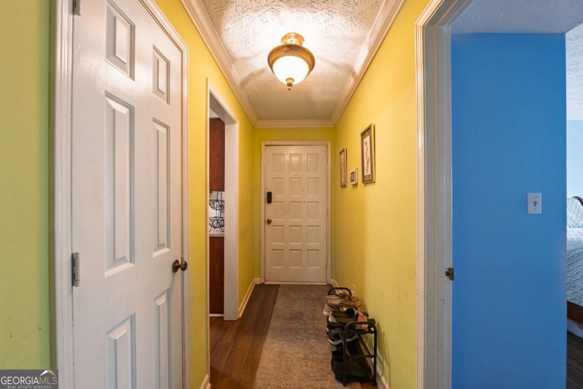 Welcome to this beautifully updated 2-bedroom, 2-bath condo offering comfort, charm, and convenience-all on the ground floor. The renovated kitchen features tile flooring, Corian countertops, a sleek tiled backsplash, updated cabinet fronts, and a pantry for extra storage. Enjoy meals in the separate dining room, then relax in the spacious living area with a cozy painted brick fireplace and large windows that open to a beautifully landscaped patio. The second bedroom is generously sized and includes access to the front patio, while the updated second bathroom adds a modern touch. The primary suite also opens to the patio and boasts a walk-in closet with built-in organization and a stunning en suite bath complete with an oversized tiled shower, granite counters, and tile flooring. With newer HVAC and fresh flooring throughout, this home is move-in ready and full of thoughtful updates. Come see it for yourself-you won't want to leave!