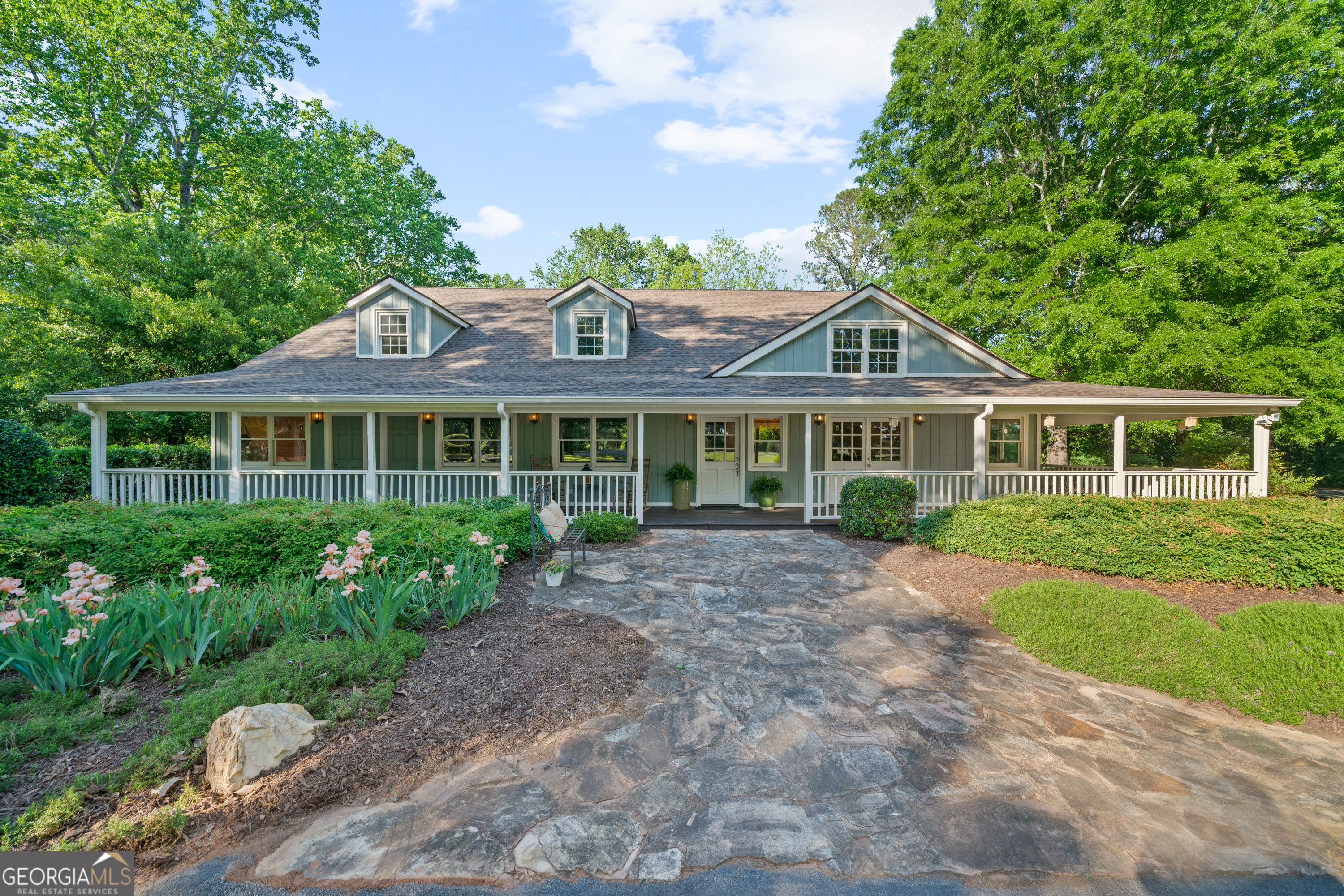 WOW! WELCOME TO YOUR VERY OWN COUNTRY SIDE PARADISE SURROUNDED BY HUNDREDS OF WOODED ACREAGE, JUST 12 MILES FROM DOWNTOWN MADISON. THIS IS SUCH A VERSATILE PROPERTY! SUITED FOR A SINGLE FAMILY HOME OR FARM, BUT, IF YOU'RE DREAMING OF A FAMILY RETREAT, FARM STAY, CORPORATE EVENT SPACE, WEDDING VENUE OR A QUIET "GET-A-WAY" THEN THIS IS FOR YOU! THE MAIN LODGE IS BEAUTIFULLY RESTORED WITH 4 BEDROOMS ON THE MAIN FLOOR. THE FOYER ENTRANCE HAS SOARING VAULTED CEILINGS & A BAR TO GREET YOUR GUESTS. THERE'S A LARGE STONE FIREPLACE IN THE FAMILY ROOM, AN EXTRA LARGE KITCHEN WITH ABUNDANT CABINETRY, AND A DREAMY LAUNDRY ROOM WITH SCENIC VIEWS. UPSTAIRS HAS TWO MORE BEDROOMS AND ADDITIONAL"FLEX" SPACES ATTACHED, PERFECT FOR GUESTS THAT NEED A LITTLE MORE SLEEPING ROOM. THE BEST PART! THERE ARE FIVE GUEST COTTAGES FIT FOR A POTTERY BARN AD! COTTAGES 1&2 ARE ATTACHED TO THE MAIN HOUSE JUST OFF THE PORCH. STEPS AWAY ARE COTTAGES 3&4 THAT ARE FULLY EQUIPPED WITH A LIVING ROOM, EN-SUITES & KITCHENETTES. COTTAGE 5 IS THE LARGEST & IT BOATS A LARGE LIVING AREA, EN-SUITE AND KITCHENETTE W/ TWO PATIOS. THE PROPERTY IS PERFECT FOR FRONT PORCH SITTING ON THE WRAP AROUND PORCH WHILE YOU ADMIRE MATURE OAK TREES AND THE SOUNDS OF WILDLIFE. THIS ALL SITS ON A PRIVATE 12 ACRES. YOU HAVE TO SEE IT IN PERSON TO EXPERIENCE!