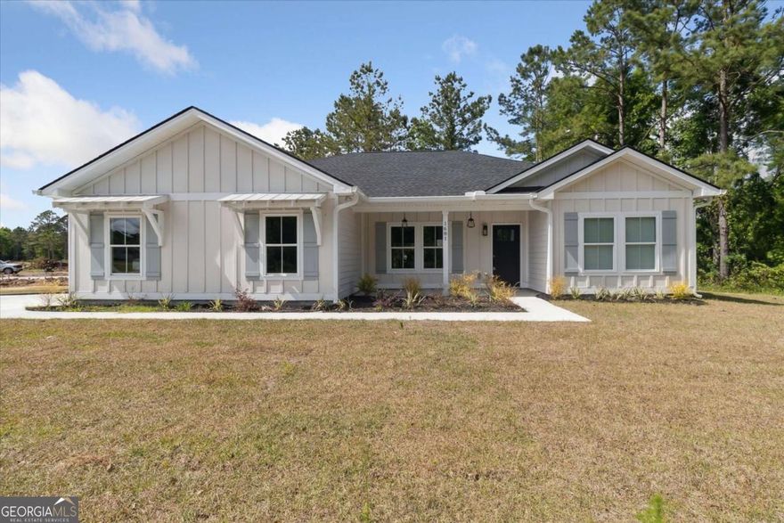 Stunning 3 bedroom, 2 bathroom home located in Ashantilly Cottages. This home has many upgrades: tiled showers, LVP throughout, a 2-car side load garage, screened-in back porch, upgraded plumbing fixtures, tiled backsplash, stainless steel refrigerator, just to name a few. This Dunhill floor plan has so much to offer. Come by and take a look at this beautiful home. Located in Ashantilly Cottages, which offers a lake, pickleball court, and a community clubhouse for its homeowners to enjoy. Just minutes to downtown Darien. Listing agent is related to a member of the construction company. Home has been tastefully staged by SimplyDwell.