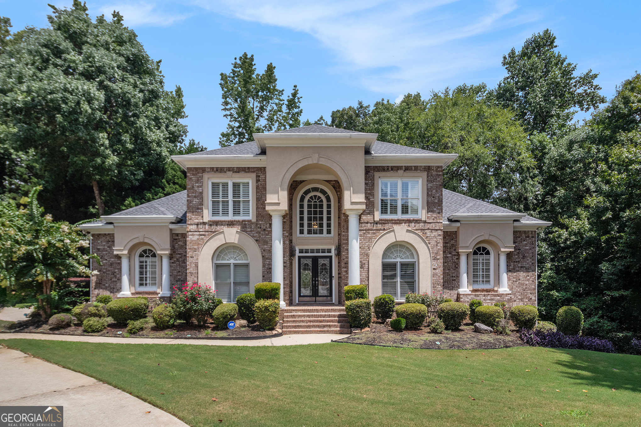 Stately three-sided brick home on a full finished basement, ideally situated in a quiet cul-de-sac. The property features a spacious three-car side-entry garage and a well-designed floor plan offering both functionality and elegance. Inside, you'll find a private office, a formal dining room, and an eat-in kitchen with solid surface countertops-perfect for everyday living and entertaining. The main-level primary suite includes two walk-in closets and a luxurious en-suite bathroom with dual vanities, a separate shower, and a whirlpool tub. Upstairs, there are three additional generously sized bedrooms. The fully finished basement adds even more living space with a second kitchen, a dining area, a cozy bonus room with an electric fireplace, an additional bedroom, a full bathroom, and multiple flex rooms ideal for a home gym, media room, or guest space. Enjoy outdoor living with a spacious deck and patio-perfect for relaxing or hosting gatherings.