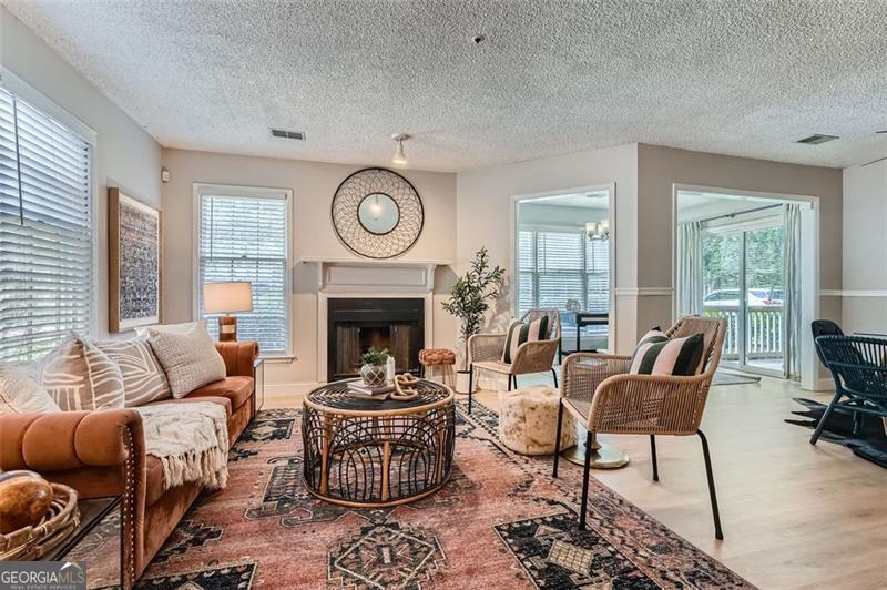 This fully renovated corner-unit condo with all-new appliances is a hidden gem, nestled in a quiet wooded neighborhood just minutes from Smyrna Market Village. Convenient parking is right outside your garden-level entrance with plenty of room for guest parking as well. Inside, find luxury plank vinyl flooring, a cozy fireplace, and an open kitchen with granite counters, subway tile backsplash and contemporary features. The bathroom features a designer vanity with stunning herringbone tile backsplash. Spacious bedroom with a walk-in closet, and extra outdoor storage complete the home. Enjoy the beautiful neighborhood pool. Amenities also include tennis courts, a playground, gazebo, and pond.
