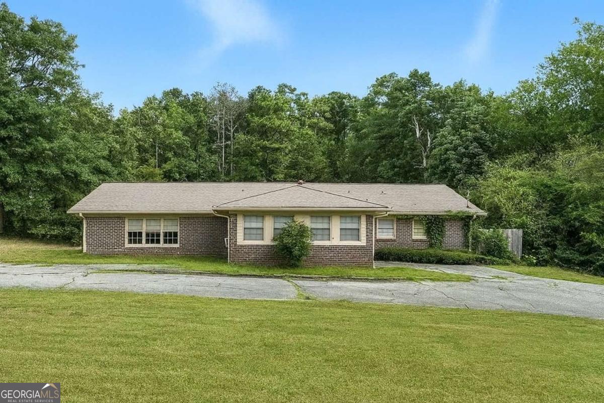 Spacious, Flexible, and Full of Potential - Ideal for Investors, House Hackers, or Multi-Generational Living Sitting on 1.3 acres in the thriving Lithonia/Stonecrest corridor, this full-brick ranch offers size, versatility, and income potential in one package. With over 2,500 sq ft, two fully equipped kitchens, multiple living areas, and separate private entries, it's perfect for multi-generational living, short- or long-term rentals, or a house hack that pays your mortgage. The layout already functions as two independent living spaces-ideal for extended family, a live-in tenant, or creating a lucrative rental setup. And with no HOA or rental restrictions, your options are wide open. While the home could benefit from some cosmetic updates, it's move-in ready with a solid structure and functional systems. That means you can update at your own pace while generating income right away. Located just minutes from Arabia Mountain's scenic trails and The Mall at Stonecrest, you'll enjoy suburban privacy with quick access to I-20 for an easy commute to downtown Atlanta. If you're an investor, creative buyer, or someone looking for a flexible home that can adapt to your needs, this property is a rare find. Bring your vision, and turn this into your income-producing or multi-gen dream property.