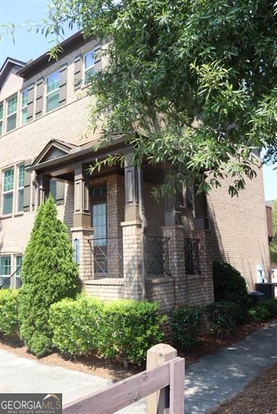 end unit with large covered front porch. Open floorplan, kitchen with SS appliances, granite counters, tile backsplash, island/breakfast bar, breakfast area and view to fireside family room and back deck. Additional room up front great for dining room, office family room etc. Master suite upstairs with additional full bedroom/bath. Two car garage on terrace level with third bedroom & full bath. Close to GA 400 and major retail, dining & parks/recreation areas.