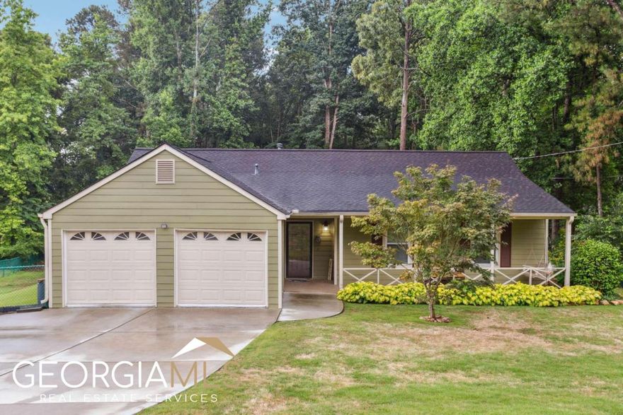 Charming 3 Bed/2 Bath stepless Ranch in sought after Hillgrove HS district! Move-In Ready home has been updated inside & out! NEW Windows! Updated Cement Siding & Roof! Fresh interior & exterior paint and updated flooring throughout! Rocking chair front porch opens to a vaulted great room w/stone fireplace!  Sunny dining area flows into the updated kitchen featuring stainless appliances, updated cabinets, NEW granite & lighting fixture and pantry!   Spacious primary suite has a walk-in closet, soaking tub, sep shower and double sink vanity. Spacious secondary bedrooms plus updated hall bath! Convenient laundry nook near the garage! Enjoy summer evenings on the NEW patio overlooking the huge fenced backyard! Some trees have been removed creating tons of usable space for gardening and room to play! NEW driveway, garage doors & opener! Set on almost 1/2 acre lot in a quiet neighborhood in one of Cobb's top rated school districts! All the conveniences of W Cobb living and just minutes to Silver Comet Trail and Kennesaw Mountain! No HOA!