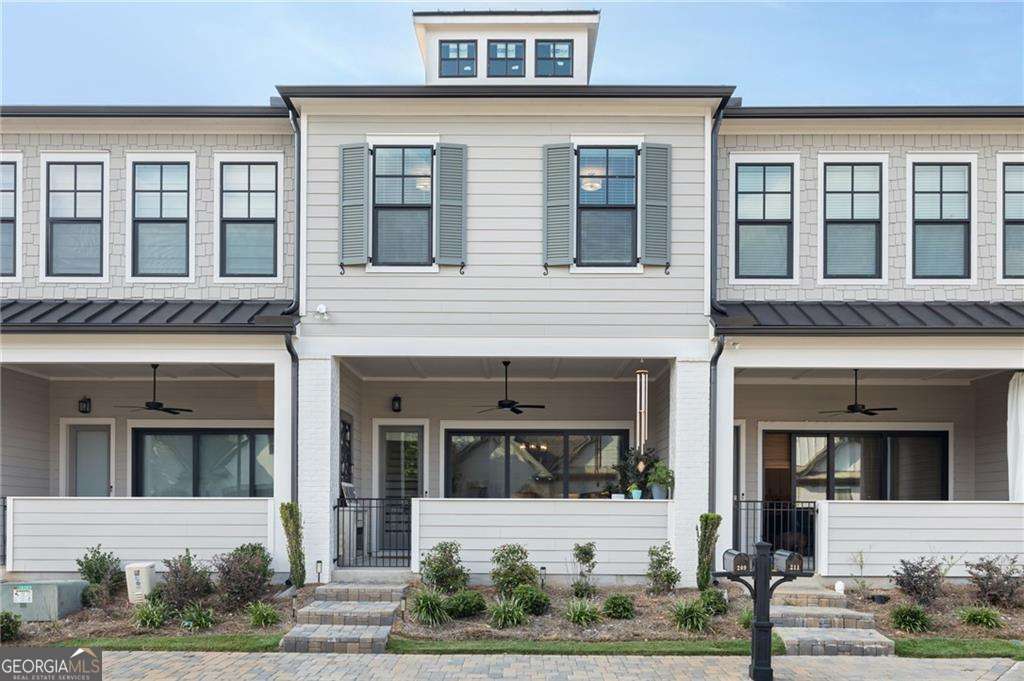 GORGEOUS Like-New Luxury Townhome in Sought After Village at Towne Lake! Beautiful finishes throughout and pics will be coming soon. Come look inside our beautiful townhome to find an inviting, open-concept floorplan. The large slider doors in the family room open to a beautiful outdoor space with a covered porch great for entertaining or enjoying your morning coffee or cold drinks after a long day. Enjoy your nights cooking and relaxing w/ an open chef-inspired kitchen & living area w/ 10+ ft ceilings. This home has modern touches like stone countertops w/ plenty of cabinets in Kitchen as well as upgraded lighting As you travel upstairs, you will notice 10ft ceilings and an open rail staircase. The owner's suite showcases a modern light double vanity w/ upgraded countertop, an oversized shower & expansive walk-in closet designed. 2 additional bedrooms with walk in closets, LOFT and full bath with tiled walls complete the upper level. If you're looking for a modern, spacious plan, this is your new home! Not only will you enjoy the stunning features of this new home, the community is also gated and beautifully maintained. Village at Towne Lake offers a range of excellent amenities to enjoy such as: a pool, pickleball court, bocce ball, fire pit, a dog park and more. Welcome to Woodstock, voted the 17th Best Place to live by Money Magazine!!