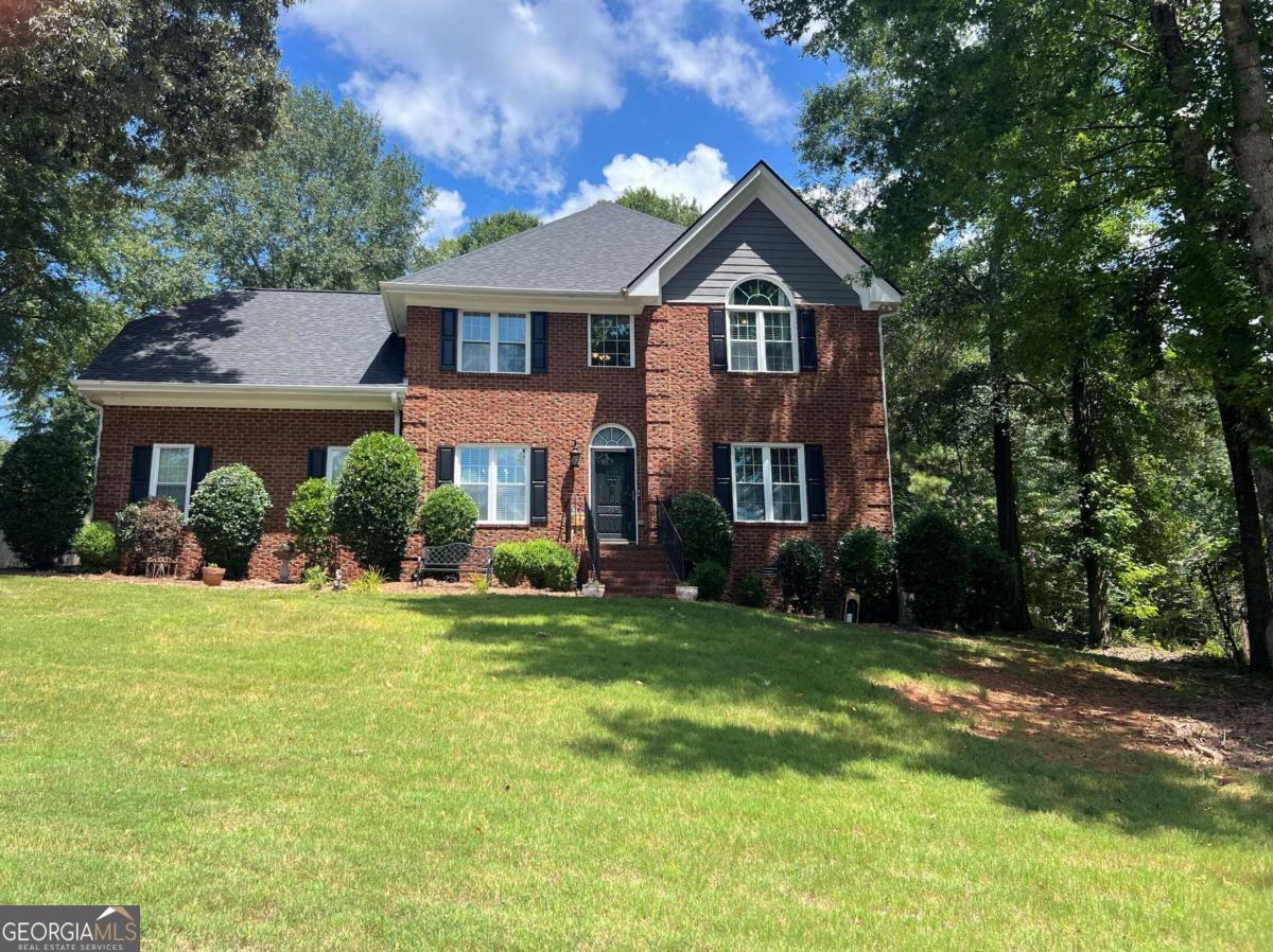 Charming Traditional Home in Sought-After Timothy Road Neighborhood. Welcome to this beautifully appointed 4-bedroom, 2.5-bath home located in McNutts Creek, one of the most desirable neighborhoods on Timothy Road. This beautiful traditional brick home sits slightly elevated from the road, with easy access to the front door. Upon entering the elegant speakeasy-style front door, there lies a charming entrance hall flanked by a formal dining room and a versatile living room or study-ideal for entertaining or quiet evenings. The heart of the home is a spacious, open-concept kitchen featuring gleaming granite countertops, custom cabinetry with ample storage, and a sunny breakfast area. The kitchen flows seamlessly into the generous family room, where a cozy fireplace adds warmth and charm. Step outside onto the expansive deck and adjacent patio, perfect for gatherings or peaceful evenings, all while overlooking a beautifully terraced and fenced backyard. Enjoy the built-in fire pit and plenty of space for outdoor play, gardening, or simply relaxing. Upstairs, you'll find all four bedrooms and a conveniently located laundry room. The luxurious owner's suite offers a tranquil retreat with a sitting area adorned with an electric fireplace ample room for a king-sized bed. The ensuite bath features double vanities, a tiled walk-in shower with glass doors and Bluetooth available for music, a soaking tub, and spacious walk-in closet. Three additional bedrooms share a well-appointed full bath, and a large bonus room/bedroom which includes two scuffy holes- perfect for additional storage or imaginative hideaways. Don't miss your chance to own this classic home in a prime location!