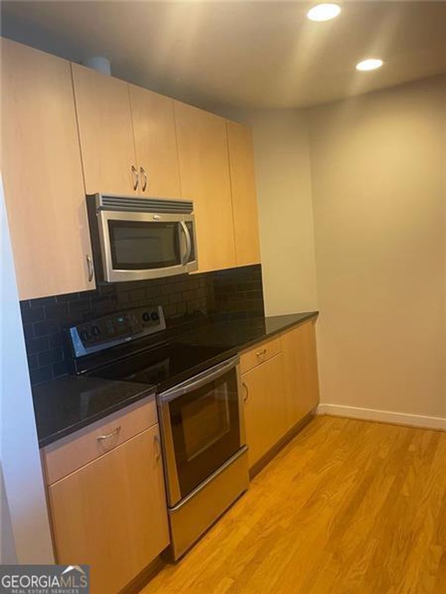 Sophisticated High-Rise Living in the Heart of Downtown Atlanta! Welcome to Unit 715 at 400 W Peachtree - a stunning 1-bedroom, 1-bath condo perched on the 7th floor of the sought-after Twelve Centennial Park building. This modern, light-filled unit offers breathtaking panoramic views of the Atlanta skyline through floor-to-ceiling windows and a private balcony, perfect for relaxing or entertaining. Inside, you'll find an open-concept layout featuring hardwood floors, high ceilings, and a sleek, contemporary kitchen with granite countertops, stainless steel appliances, and a breakfast bar that opens to the spacious living area. The generously sized bedroom includes a walk-in closet and direct access to the bathroom, which boasts a granite vanity and a large soaking tub/shower combo. Located in Twelve Centennial Park, you'll have access to resort style amenities including a saltwater pool, gym, 24-hour concierge, club room, grill area, media room, and more! Beginning just steps away from your building are the hundreds of shops, restaurants, bars, and event spaces downtown Atlanta has to offer. Prime downtown attractions include the State Farm Arena, GA Aquarium, World of Coca-Cola, Centennial Olympic Park, Skyview Ferris Wheel, College Football Hall of Fame, and the Mercedes-Benz Stadium home to the Atlanta Falcons, Atlanta United, Superbowl LXII in 2028, and the FIFA World Cup in 2026. The nearby MARTA and highway provide quick access to all parts of metro Atlanta including the AIRPORT, Midtown, Buckhead, Truist Park, and more! This location is ideal for both convenience and luxury. You'll also enjoy 1 assigned parking spaces. Whether you're a first-time buyer, investor, or looking for a conveniently located home in the city, Unit 715 delivers location, style, and comfort.