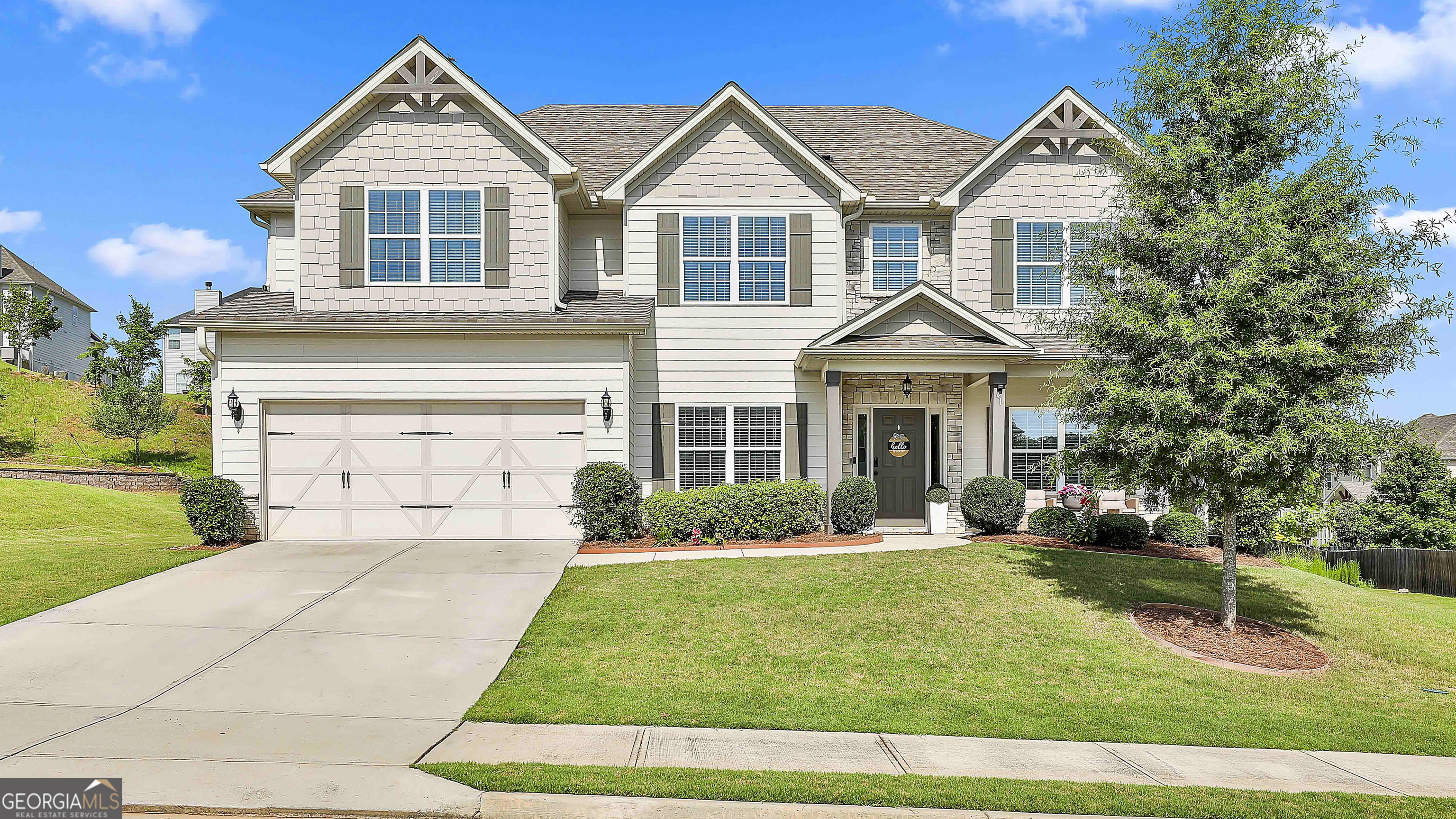 Welcome to this beautifully designed 5-bedroom, 3-bath craftsman-style home offering 3,151 sq ft of thoughtfully curated living space. Nestled in a sought-after community in Sharpsburg, GA, this home features custom trim work throughout, adding a touch of character and charm. The main level boasts a private guest suite, ideal for visitors or multi-generational living. Entertain in style on your outdoor game-day porch with fireplace, perfect for grilling out and watching the big game, all while overlooking a spacious, fenced backyard complete with a play-set-ready for family fun! Upstairs, you'll find four generously sized bedrooms, including a luxurious owner's suite, and flexible space to accommodate your lifestyle. Enjoy access to community amenities including a pool and clubhouse, creating a true neighborhood feel. Located just minutes from Newnan, Peachtree City, and Senoia, with convenient access to dining, shopping, and top-rated schools, this home offers both comfort and convenience. Don't miss your chance to own this exceptional property-schedule your private showing today! Open House Sunday July 27, 2-4pm.