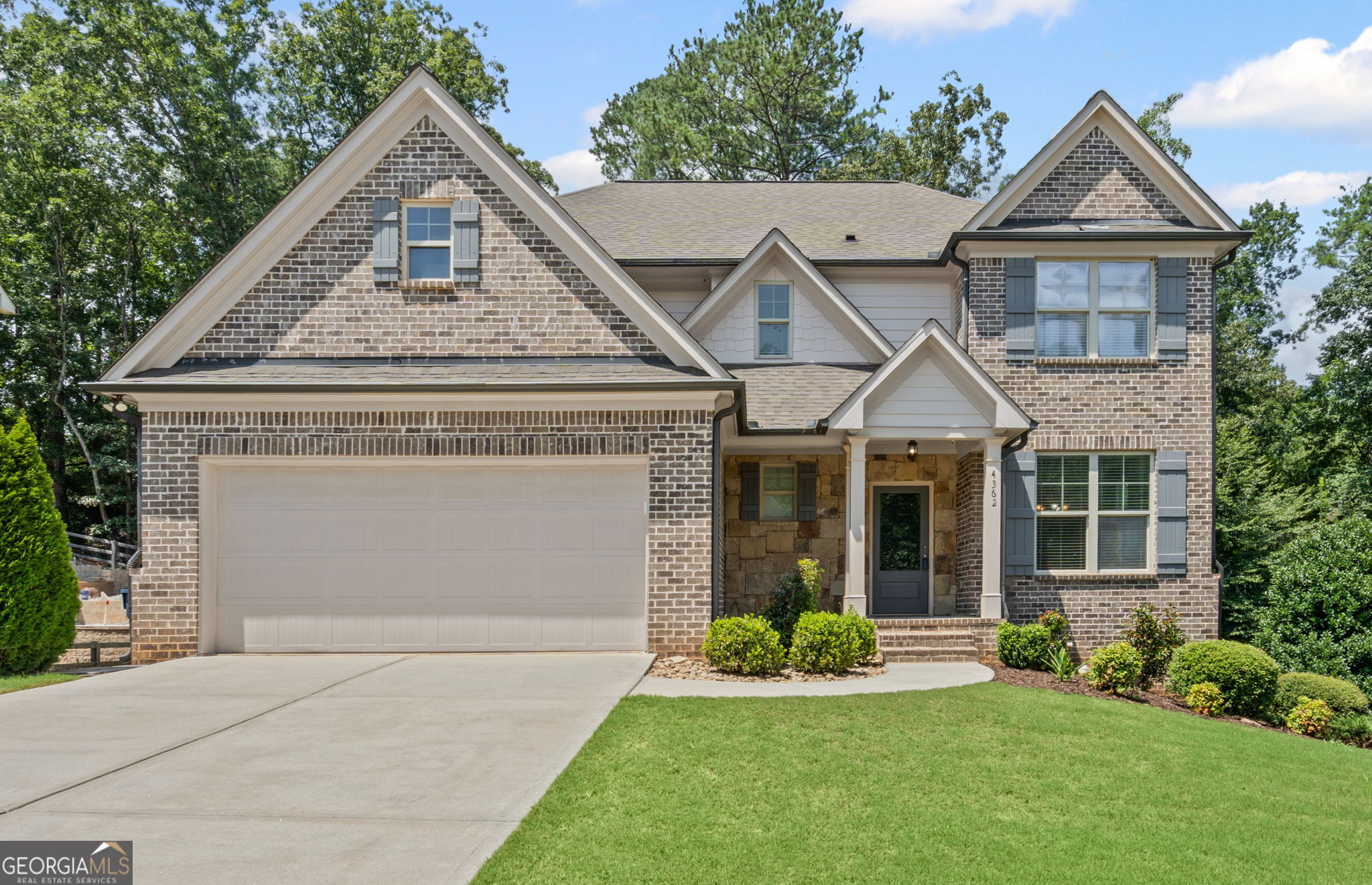 Master on Main, Mill Creek High, Daylight Basement, Open Floorplan, Covered Deck! Price Improvement, over 3600 sq ft, this home is a great value! Newer home with 5 BR, Upstairs Media rm and Partially Finished Daylight Basement. Features include Gourmet Kitchen with Island and Granite Ctops, Hardwoods on Main, Coffered Ceiling & Crown Molding in Dining Rm. All this and you can relax on your Covered Back Deck with lovely Level Wooded Yard.