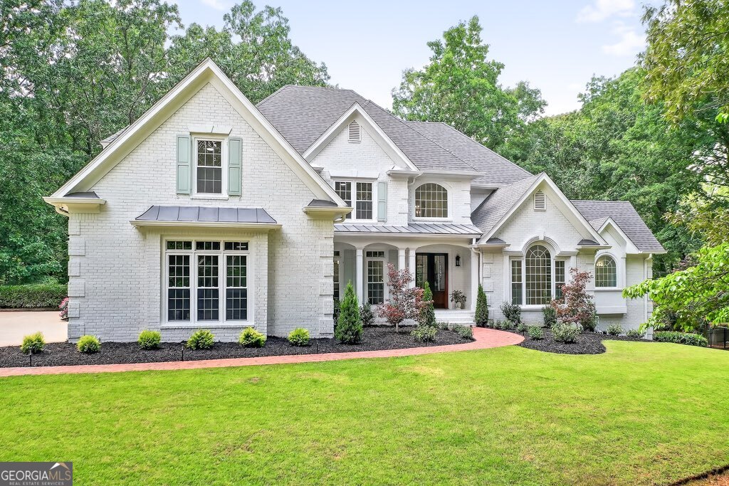 Welcome home to your dream estate! Nestled within an exclusive enclave, this fully-renovated residence sits on a sprawling 3.7-acre lot, offering the perfect balance of privacy and convenience. Located near top-rated schools-Pope, Hightower Trail, and Tritt-along with premier amenities and major thoroughfares, this home provides a peaceful retreat without compromising accessibility. Home features hardwood floors throughout its entirety, complete with upgrades galore. The main level has an entire dedicated master wing with beautiful trim, custom-built walk-in closet, dual-vanities with marble floors, make-up area, marble steam shower, separate soaking tub, private water closet, laundry room with sink - all overlooking the pool and private wooded yard. Grand two-story foyer welcomes you with an elegant dining area, massive great room with exposed beams, two-story stone stacked hearth, and views into the stunning kitchen. The kitchen features custom white cabinetry, all new stainless steel appliances with gold accents, shiplap, and matching stone on the backsplash and custom hood vent. There is high-end quartz everywhere you look, complete with a beautiful, accented kitchen island. Enjoy the abundance of natural light in the casual sitting room or the breakfast nook. Every window in the home was just replaced. Main level is complete with a moody powder room, butler's pantry, and don't miss the hidden mudroom, encased by a Murphy door. The upstairs has new banisters and balusters, 4 bedrooms, 3 bathrooms, and designer-inspired finishes in all of the newly appointed bathrooms. The terrace level features hardwoods that match the rest of the estate. Home is perfect for multi-generational living as the lower level has a bedroom and a full bathroom. You have a dedicated exercise room that could be repurposed as an office. Plenty of space for a billiards table or other activities, an abundance of storage, and last but certainly not least, a custom wet bar that envelops the exquisite home theatre. Step outside and enjoy your 30,000-gallon PebbleTec pool, complete with all-new pool decking, new tile, new coping, drainage systems, and a hot tub. The perfect place to have fun with family and friends or unwind after a long day. This is a smart home that provides control of security, climate, media, irrigation, and pool from your phone. Every inch of this home was touched, and the combination of craftsmanship and designer inspiration makes it a true stunner. Every fixture in the home is new, multiple new HVAC systems, a tankless water heater, the list goes on and on. Offering a rare blend of seclusion and convenience in one of East Cobb's most coveted locations, this estate is just minutes from Roswell's vibrant Canton Street and easy access to 400. This is a rare opportunity to find a home that is worthy of HGTV, combined with the coveted East Cobb location, sitting on nearly four private acres with a pool.