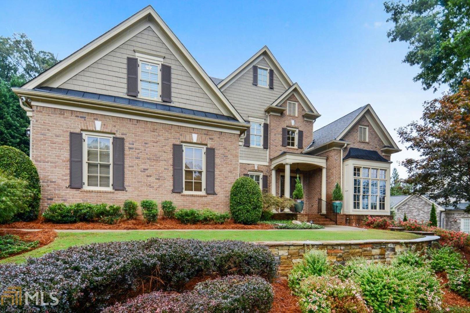 Gorgeous home filled with natural light perfect for every day living and entertaining located in The Manor in sought after Vinings Estates. High end finishes and upgraded features throughout. Beautiful entrance foyer welcomes you with view through to two story great room bathed in light with a soaring wall of windows, coffered ceiling, and grand fireplace. A banquet size formal dining room and office with built in cabinetry feature handsome millwork. Bright open floor plan with updated, huge white kitchen with new gleaming white quartz countertops, refinished cabinets  and stainless steel appliances open to large keeping room with stone fireplace and breakfast area. Oversized owner's suite on the main level with sitting area and fireplace, luxurious bath with dual vanities, soaking tub, large shower and spacious walk in closet. Wonderful screened porch and deck with hot tub overlook walk out backyard. Upstairs includes 3 generous sized secondary bedrooms each with en suite baths. Recently renovated terrace level is an entertainer's dream featuring wooden ceiling details, exposed brick walls, an additional home office, guest suite with full bath, media room, game room, kitchen and sitting room with fireplace with French doors opening to new stone patio and a putting green! A three car garage and professionally landscaped yard round out the incredible features. Walk to Whitfield Academy and nearby hiking trails. Close proximity to Silver Comet Trail and The Battery and easy access to I-75 and I-285.