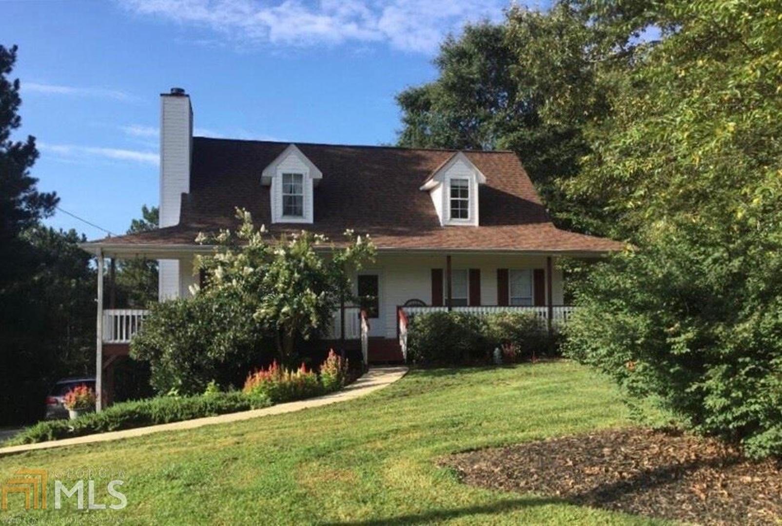 Look no further, this is it! 4 BR 2.5 Bth Hardwood floors throughout main level & upstairs. Situated on a private half acre lot in highly sought North Paulding High School district. Cozy up to the fireplace, relax on the back deck overlooking your private backyard or enjoy your coffee on the rocking chair front porch. Recently finished basement has waterproof LVP & features a bedroom & flex space - office, man cave, game room, etc. All bedrooms have walk-in closets plus multiple other storage options. 6 yr old architectural shingles. 3 yr old HVAC. **MORE PHOTOS COMING