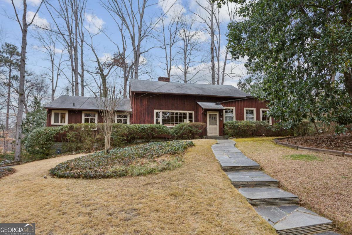 Such a special property! Believed to be one of the original farmhouses in Brookhaven, this home has been in the same family for over 60 years. It is a wonderfully charming home on approximately .70-acres nestled in the middle of Narmore Drive in Historic Brookhaven. This is a fantastic opportunity to renovate and make this house your own or build your dream home. The one-story home features gorgeous pine flooring throughout, as well as a spacious walk-up attic with a permanent staircase. The foundation is granite and the exterior is board and batten pine. The living room features a masonry fireplace surrounded by a wall of bookshelves and the dining room is large and can easily seat 10. The family room with brick fireplace features additional bookshelves plus a wall of glass overlooking the backyard and has access to the deck and covered patio. There is plenty of room in the kitchen for your breakfast table with beautiful views of the backyard. The primary bedroom has multiple closets and an en suite bathroom with double vanity. Two additional bedrooms are good-sized with hardwood floors under the carpet and share a hall bath. An additional small bedroom or office with full bathroom is located on the opposite side of the home. There is a drive-under, two-car garage with a storage area. The elementary school district is award-winning and the location is fabulous for shopping, restaurants, and groceries, plus easy access to major roads and highways. Home to be sold "as-is".
