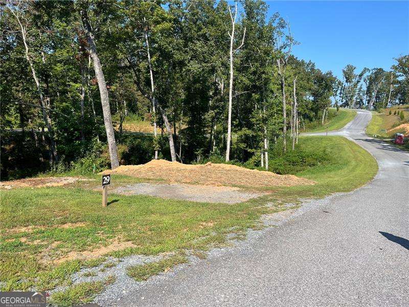 Welcome to your slice of tranquility in the North Georgia mountains. Nestled in the peaceful Jakes Landing Overlook subdivision, 148 Jakes Landing Way S offers just over one acre of wooded land, providing the perfect backdrop for your dream home or private mountain retreat. The residential zoning allows flexibility for a variety of home designs, and with modest property taxes, it's an affordable opportunity to own land in this desirable area. Located only a short drive from downtown Ellijay, you'll enjoy the charm of local shops, restaurants, and community events, as well as easy access to hiking, fishing, and the outdoor adventures that make this region so special. Whether you're looking to build now or invest for the future, this lot offers the perfect combination of natural beauty, convenience, and potential.