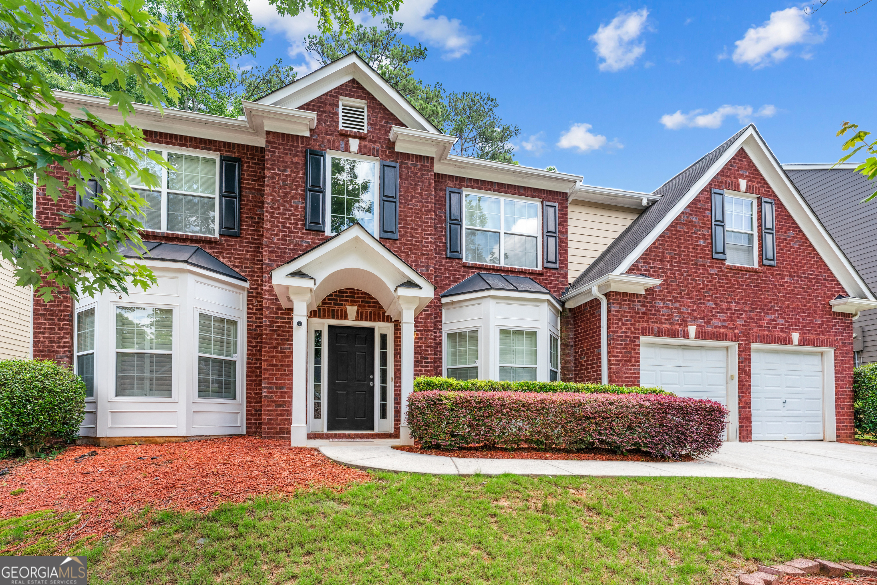 Welcome to the crown jewel of Saddlebrook-where elegance, space, and craftsmanship come together in the largest and most refined home in the neighborhood. Spanning nearly 3,500 sq ft, this exquisitely upgraded residence offers luxurious living at every turn. Step into a grand 2-story foyer adorned with imported Canadian Red Oak hardwoods, finished onsite for a rich, timeless look. Custom iron stair spindles, hand-carved wood accents, and updated chandeliers add a bespoke touch throughout. Plantation shutters provide both style and privacy, while the newly added front portico offers a warm and welcoming entry. The gourmet kitchen features granite countertops, rich cherry cabinetry, stainless steel appliances, and opens seamlessly to a spacious great room-perfect for entertaining. Formal living and dining rooms, a private office, a half bath, and a laundry room complete the main level. Upstairs, the oversized primary suite is a true retreat, featuring a large sitting area ideal for a library or office, a spa-like bath with a soaking tub and separate shower, and an expansive walk-in closet (with easy potential to create a fifth bedroom). Three additional bright bedrooms and a full bath offer space for all. Outside, enjoy a beautifully landscaped, low-maintenance yard with a concrete patio for gatherings. Major system upgrades include a new HVAC system, a new furnace, a new water heater, and more, providing peace of mind for years to come. Located just minutes from Dobbins Air Reserve Base, Truist Park, Cobb Galleria, Hartsfield-Jackson Airport, and downtown Atlanta, this home blends luxury, convenience, and character in one unforgettable package. Schedule your private showing today!