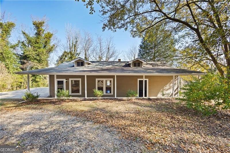 Welcome to this charming farm-style home, ideally situated less than two minutes from historic downtown Cartersville, where shopping, dining, and local charm await. Nestled on a generous lot, this home invites you in with its spacious front porch-perfect for relaxing and enjoying the neighborhood. Inside, you'll find beautiful original hardwood floors flowing throughout most of the home, complemented by modern updates, including a newer roof and HVAC system (approximately 5 years old) and a 3-year-old water heater. A large poured-concrete parking pad provides plenty of space for multiple vehicles or even an RV. Offering the perfect balance of character, comfort, and convenience, this home is a rare find in a highly sought-after location!