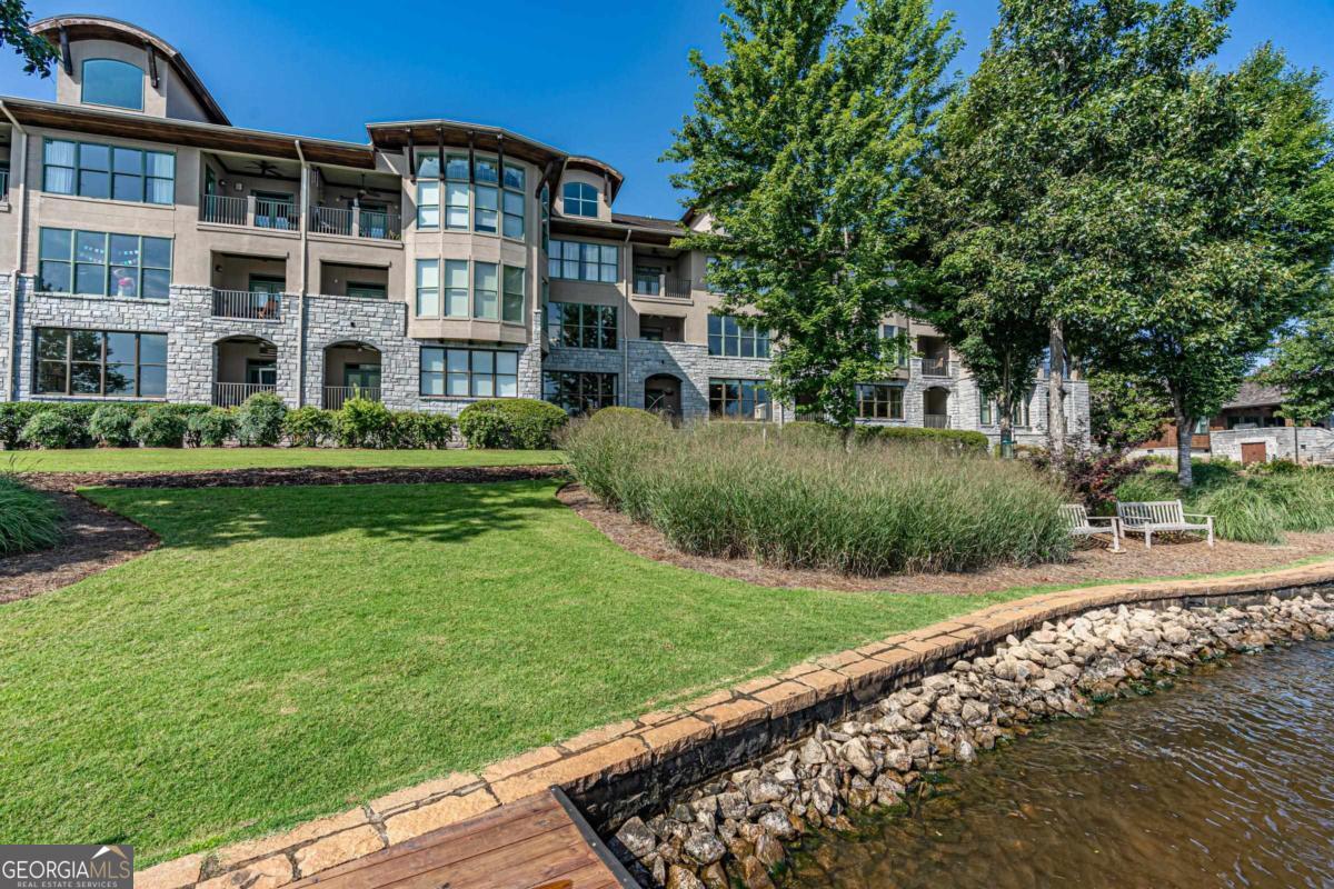 3rd-Floor Lakefront Condo in Cuscowilla at Lake Oconee Enjoy luxury lakeside living in this 3-bedroom, 3-bath end-unit with loft, located in the gated golf community of Cuscowilla. This bright, open floor plan features a spacious kitchen with granite countertops, stainless steel appliances, breakfast bar, and walk-in pantry. The living area boasts hardwood floors, high ceilings, and a wall of windows leading to a covered balcony with stunning lake views. The oversized primary suite offers a garden tub, separate shower, dual sinks, walk-in closet, and breathtaking waterfront scenery. Two additional bedrooms and baths provide comfort for guests. Community amenities include a lakeside pavilion, beach, grilling areas, and optional membership to the golf course, clubhouse, pool, tennis, and pickleball courts-all just a short walk away. 1 year home warranty to buyer at close.