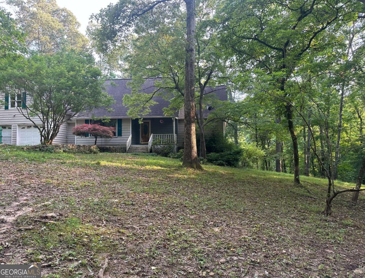 This home is full of potential and ready for your personal touch. Tucked away on three private acres in a quiet cul-de-sac, this charming 3 or 4 bedroom, 2.5 bath home offers the perfect blend of seclusion and convenience-just minutes from all that downtown Jasper has to offer. Step inside to discover a spacious layout with the master on the main level, featuring his and her closets and a private bath complete with a built in vanity. The inviting living room showcases a beautiful masonry fireplace, perfect for cozy evenings, while the large laundry room on the main level adds everyday convenience. Upstairs, you will find 2 more large bedrooms and a bath in between. In a separate entrance, you will find a generous bonus room above the garage-ideal as a game room, home office, or optional fourth bedroom. Enjoy the outdoors with a rocking chair front porch, a large back deck and a fenced-in backyard-great for pets, play, or quiet evenings under the stars. The landscaped front yard adds extra to the home. If you are looking for privacy, space, and comfort-without sacrificing proximity to town, this home checks every box. Schedule your showing today! This home is being sold as is.