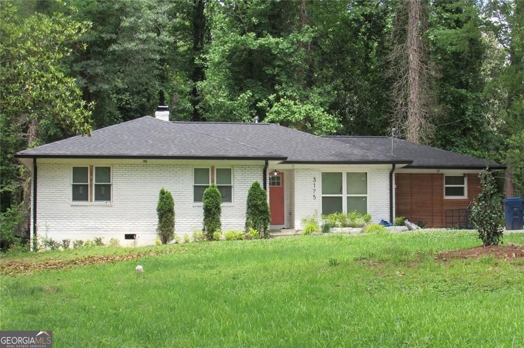 Completely Renovated Brick Ranch in Prime SW Atlanta! Welcome to this beautifully renovated 4-bedroom, 2.5-bath ranch-style home, nestled in the heart of highly sought-after Southwest Atlanta. This four-sided brick gem sits on a spacious lot with an extended driveway, a large front yard, and a generous backyard featuring a patio-perfect for entertaining or relaxing outdoors. Step inside and be wowed by the modern open-concept layout with gleaming hardwood floors throughout-no carpet anywhere. The living and dining areas flow seamlessly together, centered around a cozy fireplace that adds warmth and charm to the space. The gourmet kitchen is a true showstopper, featuring pristine white cabinetry, quartz countertops, and a large island with seating, an undermount sink, and smart appliances-including a gas stove with built-in air fryer, and a washer and dryer for added convenience. Retreat to the spacious master suite, complete with a spa-inspired bathroom boasting dual sinks, a soaking tub, and chic barn doors. Each of the four bedrooms offers ample space, natural light, and modern finishes. Enjoy peace of mind with all-new systems, including a brand-new roof, gutters, HVAC, electrical, water heater, windows, and fresh paint inside and out. This home blends style, comfort, and efficiency with smart home features and quality craftsmanship throughout. Don't miss your chance to own this move-in-ready masterpiece in one of Atlanta's fastest-growing neighborhoods!