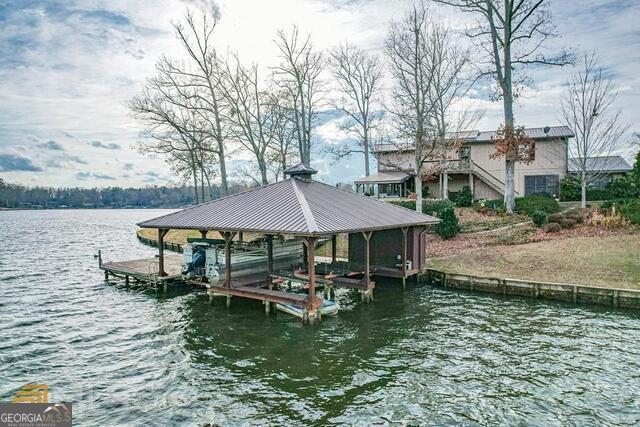 Welcome to your private lakeside oasis! This stunning property offers a spacious 4-bedroom, 3-bath main home paired with a detached 2-car garage featuring its own 1-bedroom, 2-bath guest suite-perfect for hosting family, friends, or creating a private retreat. Step outside to enjoy your fenced-in backyard with a heated pool and spa, designed for year-round relaxation. A full bath on the lower level of the guest suite provides the ideal setup for poolside convenience, while the upper level adds another full bath for comfort and versatility. With expansive lakefront views, generous living space, and resort-style amenities, this property seamlessly blends everyday comfort with vacation-worthy living. Whether you're entertaining guests, enjoying quiet mornings by the water, or relaxing in the spa at sunset, this home has it all.