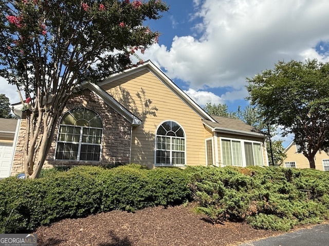 Exceptionally clean condo, with loads of natural light and very well maintained. This quiet community is meticulously landscaped with a strong HOA, a host of high engagements and ongoing event for its residents and is conveniently located to shopping, restaurants, entertainment, highways, and Stone Mountain Park. The Villas of Stone Mountain features a pool, fitness center, and a club house that can be used for your private events. This ranch unit features 3 spacious bedrooms, 2 full bathrooms one with a double vanity, a four season sunroom with french doors, an open floor plan, neutral paint, and a 2 car garage. Schedule a tour today to see this lovely condo!