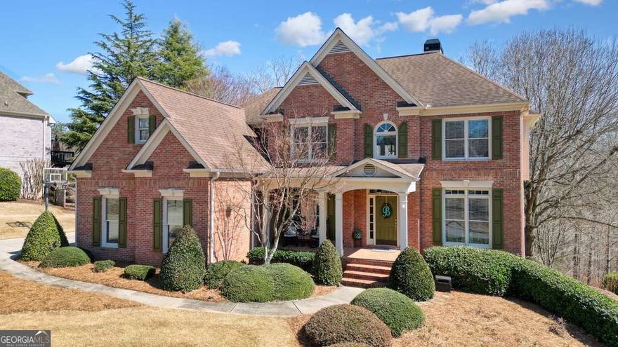 Nestled in the picturesque swim/tennis neighborhood of Laurel Brooke, this 6-bedroom, 5-bathroom, 3-vehicle garage, 3-sided brick beauty awaits its new owners. The rocking chair front porch with statuesque columns and landscape lighting invites you into the home surrounded by pristine landscaping and a private, tree-lined backyard with no neighbors behind.    Proudly owned by its original owners, this beautiful, well-maintained home features real hardwood floors throughout the main living areas. The two-story foyer welcomes you with grand scale, while the formal dining room adorned with custom millwork offers the perfect space for entertaining in style. A versatile den awaits your personal touch - whether you need a home office, playroom, or music room, it's ready to serve.    The spacious two-story great room features a stacked stone wood-burning fireplace flanked by built-in bookcases and a surround sound system, all highlighted by floor-to-ceiling windows with seasonal views of the backyard. With ample space, the great room offers endless possibilities for arranging furniture and creating the perfect heart-of-the-home vibe.    The eat-in kitchen features real wood cabinetry, walk-in pantry, stainless steel appliances, a center island for additional seating or food prep and cabinetry storage. For those who love to entertain, the butler's pantry/dry bar is ready to serve your guests, while the planning center adds convenience for keeping life organized.    On the main level, you'll also find a laundry room with plenty of cabinetry for storage and a bedroom with an ensuite, perfect for guests. When you're ready to explore upstairs, take your pick of two staircases leading to the second level.    At one end of the catwalk are two generously-sized bedrooms that share a charming Jack-n-Jill bathroom. On the other end, a secondary bedroom with its own ensuite, while the grand primary suite is your personal retreat. This spacious room features a tray ceiling, wall sconces for evening reading, and a cozy sitting area with built-in bookcases. The ensuite features two vanities, a whirlpool soaking tub, a free-standing shower, a private water closet, and a massive walk-in closet that will keep your growing wardrobe organized.    The finished terrace level is ideal for entertaining or multi-generational living. With durable LVP flooring throughout, this level boasts a family room with a built-in Bose surround sound system and a large screen TV, making it the ideal space for watching movies or sports. The game room will keep everyone entertained, and the wet bar (complete with white cabinetry, granite countertops, sink, dishwasher, and wine fridge) makes hosting a breeze. The terrace level also includes a bedroom with an ensuite and two additional rooms that could easily serve as a gym, office, den, or library - the possibilities are endless! You'll also find unfinished space for easy storage.    Step outside and enjoy the expansive upper-level deck or retreat to the covered terrace-level patio, offering ceiling fans and a bench swing for relaxing. Whether you're hosting a barbecue, enjoying a quiet morning, or watching nature in the backyard, these outdoor spaces are made for creating memories.  This home truly has it all - space, style, and a location that can't be beat.