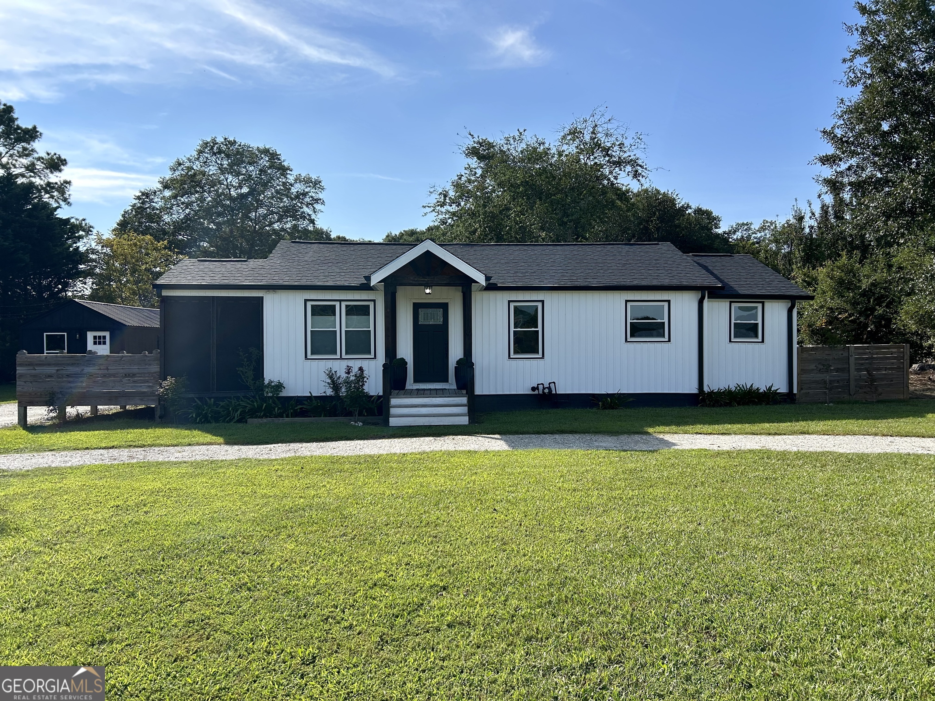 Welcome to your charming new home in the heart of Hartwell! Nestled on 1.5 acres, this property is the ultimate package of convenience and modern upgrades. Imagine being just a few minutes from downtown's buzz and Hartwell Lakeside Park, where you can launch your boat and spend the day on the water. Inside, no detail was spared. The home boasts a fresh, open feel with wood flooring, gleaming granite countertops, and sleek stainless steel appliances. The 2-bedroom, 2-bath layout is incredibly functional, with a laundry room that offers direct access outside, perfect for a mudroom. Ready to relax? The large side deck is your private oasis, leading to a fenced yard and a cozy covered porch. Looking for a space to get creative, run a business or use as rental income? A custom built finished building on the property is equipped with electricity, a bathroom and laundry room provides, a unique opportunity for a hair salon, workshop, or whatever you can dream up! A second mini-building in the back provides all the extra storage you need. Don't miss out on this amazing home!