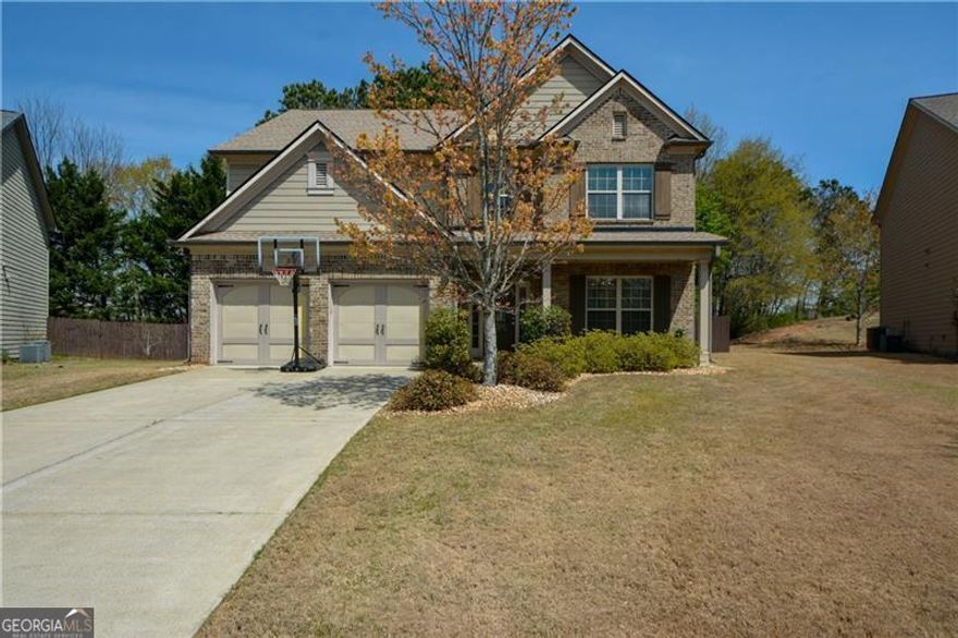 Priced to sell in sought after Hanover Place! This lovely home has great curb appeal boasting a covered front porch and lush landscaping. Through the front door is a spacious foyer open to a light filled formal dining room or make it a convenient home office. The foyer continues down the hall into an open floor plan showcasing a large great room, breakfast room, and kitchen. The great room features a two story ceiling, wood flooring and a cozy fireplace flanked by built-in cabinetry. There are also two stories of windows overlooking the private backyard! Open to the great room is the spacious kitchen with granite counters, stainless steel appliances and an adjoining breakfast room. Great for entertaining and having conversations with family and friends! Also on the main floor is the fourth bedroom and a full bathroom. So convenient for both family and visitors! At the top of a beautiful open staircase are two more bedrooms sharing a full bathroom. There is also a second floor laundry room for extra convenience. The oversized, primary bedroom is also on the second floor boasting a detailed tray ceiling. Lot's of room for relaxing and enjoying a quiet evening. The primary spa-like bathroom has a separate soaking tub, shower, and double vanity. Two walk-in closets complete this beautiful space. Step outside from the great room and kitchen to a large, flat, private, fenced backyard. Enjoy your morning coffee or afternoon refreshment on the shaded wooden deck or on the concrete patio. Enjoy sitting around the toasty firepit on a cool fall evening! Hanover Place is an active swim/tennis neighborhood with a zero entry pool, playground, tennis courts and clubhouse. Only 5 minutes to 400, shopping, restaurants and Halcyon Forsyth!
