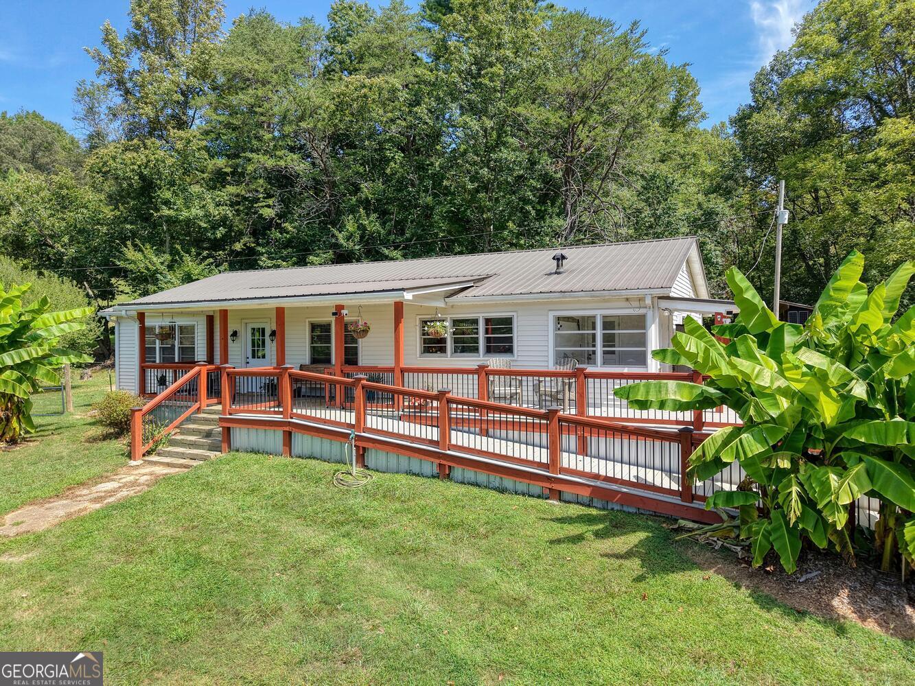 Charming 1946 Collins Road Home on Nearly 7 Acres of Unrestricted Land! Welcome to a piece of history in the heart of Choestoe! Just down the road from the historical one room school house is this three-bedroom, two-bath home filled with warmth, charm, and character you can feel the moment you step inside. You'll love the original hardwood floors, the beautiful solid wood doors, and the large, inviting rooms that make this home perfect for gathering with family and friends. The cozy sunroom is the perfect spot for morning coffee, and the mini-split systems throughout the house keep you comfortable in every season. Downstairs, the full unfinished basement offers a garage, plenty of storage, and room to grow. Outside is where the magic continues-nearly 7 acres to enjoy, with mountain views, gorgeous show stopping sunsets from the porch, and plenty of space for a garden, horses, or a mini-farm. The property also has a fenced yard for your furry friends, a ramp for easy access to the home, handy sheds, and even blueberry bushes and banana trees to enjoy each summer. This home blends the best of old-fashioned charm with everyday convenience. An inviting place to put down roots, enjoy the land, and soak in the beauty of the Choestoe valley.