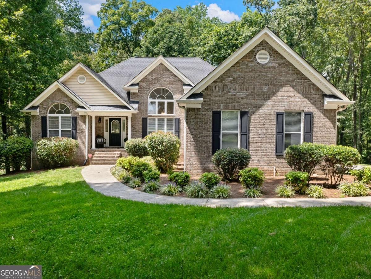 Rare Ranch on Full Basement in Prime Braselton Location This hard-to-find ranch home sits on a private 1+ acre lot in a quiet enclave of just 15 homes-with no HOA. Conveniently located minutes from Chateau Elan, the Northeast Georgia Medical Campus, and quick access to I-85, this property offers both privacy and accessibility. The main level features a split-bedroom layout, placing the spacious Owner's Suite on one side and two secondary bedrooms with a full bath on the other. The fireside family room with hardwood floors opens into a vaulted dining room, where expansive windows flood the home with natural light. A cheerful breakfast nook just off the kitchen provides peaceful views of the wooded backyard. Step outside to a large screened porch, perfect for year-round enjoyment of the outdoors. The full unfinished basement with high ceilings and a stubbed bath offers endless opportunities for expansion-whether additional bedrooms, recreation space, or an in-law suite. This property combines the ease of single-level living with the rare flexibility of a basement home in a sought-after area.