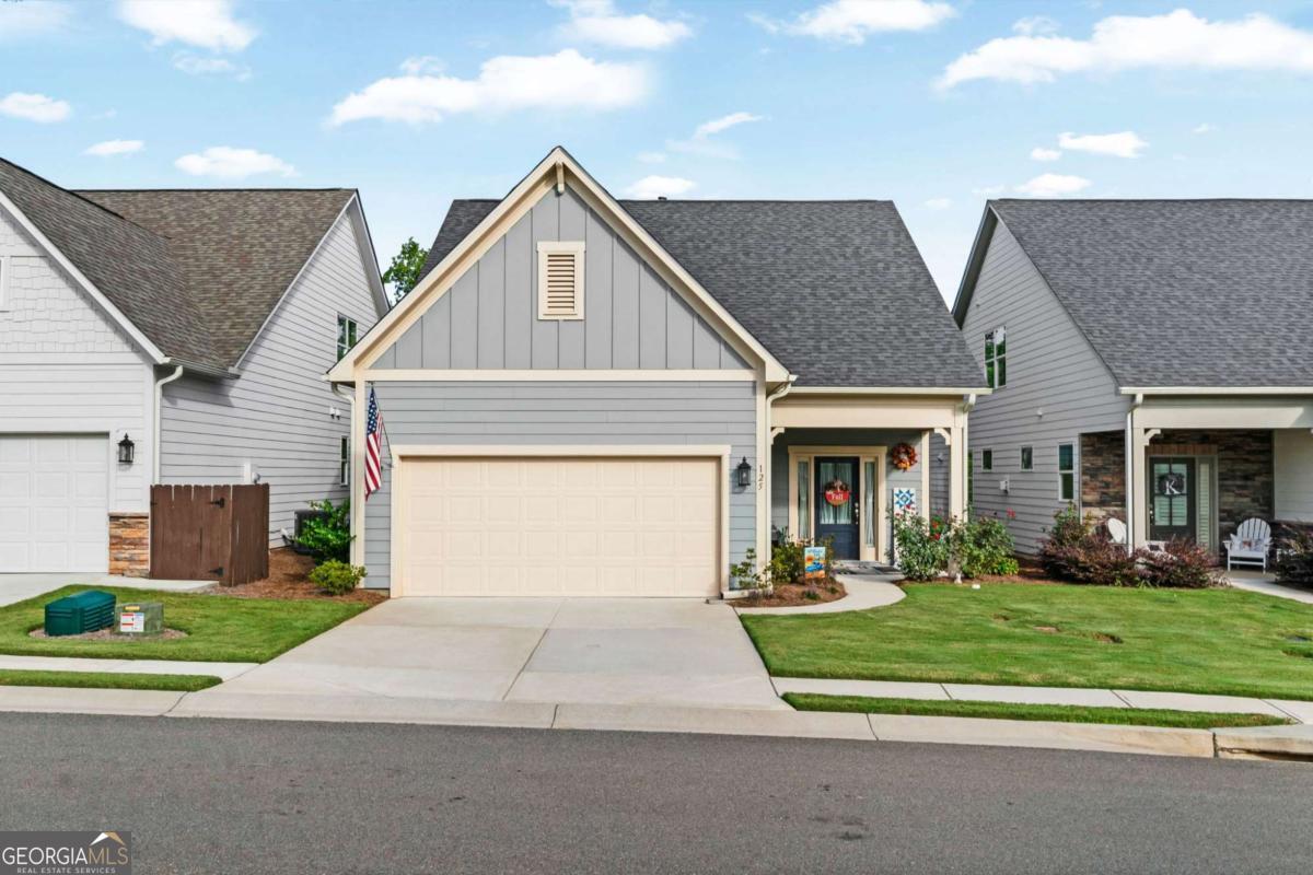 Are you ready to embrace the 55+ lifestyle while still answering the call of the mountains? Welcome to Grandview at Gateway-where carefree living meets the best of North Georgia's outdoor lifestyle. If you've been dreaming of mountain views, nearby wineries, hiking trails, lakes, and fishing-all while enjoying the simplicity of maintenance-free living-this is the home for you. Step inside this like-new construction featuring a master on the main level with an oversized shower and double vanities, hardwood floors throughout, and an updated kitchen with a large island perfect for entertaining. Upstairs, you'll find a spacious loft, plus an extra bedroom and full bathroom-ideal for guests or a home office. Enjoy the outdoors year-round with a covered and screened-in porch as well as a deck overlooking the peaceful forest, offering the perfect backdrop for morning coffee or evening relaxation. Beyond the home itself, this community offers resort-style amenities: a stunning clubhouse, sparkling pool, and lively pickleball courts. Imagine spending your mornings on a hike or winery tour, and your afternoons relaxing with friends by the pool or joining a pickleball match-without ever worrying about lawn work or exterior maintenance. This beautiful property combines low-maintenance living with luxury finishes, outdoor serenity, and easy access to everything the North Georgia mountains have to offer. If you're looking for a place where every day feels like a getaway while still keeping life simple, you'll find it here.