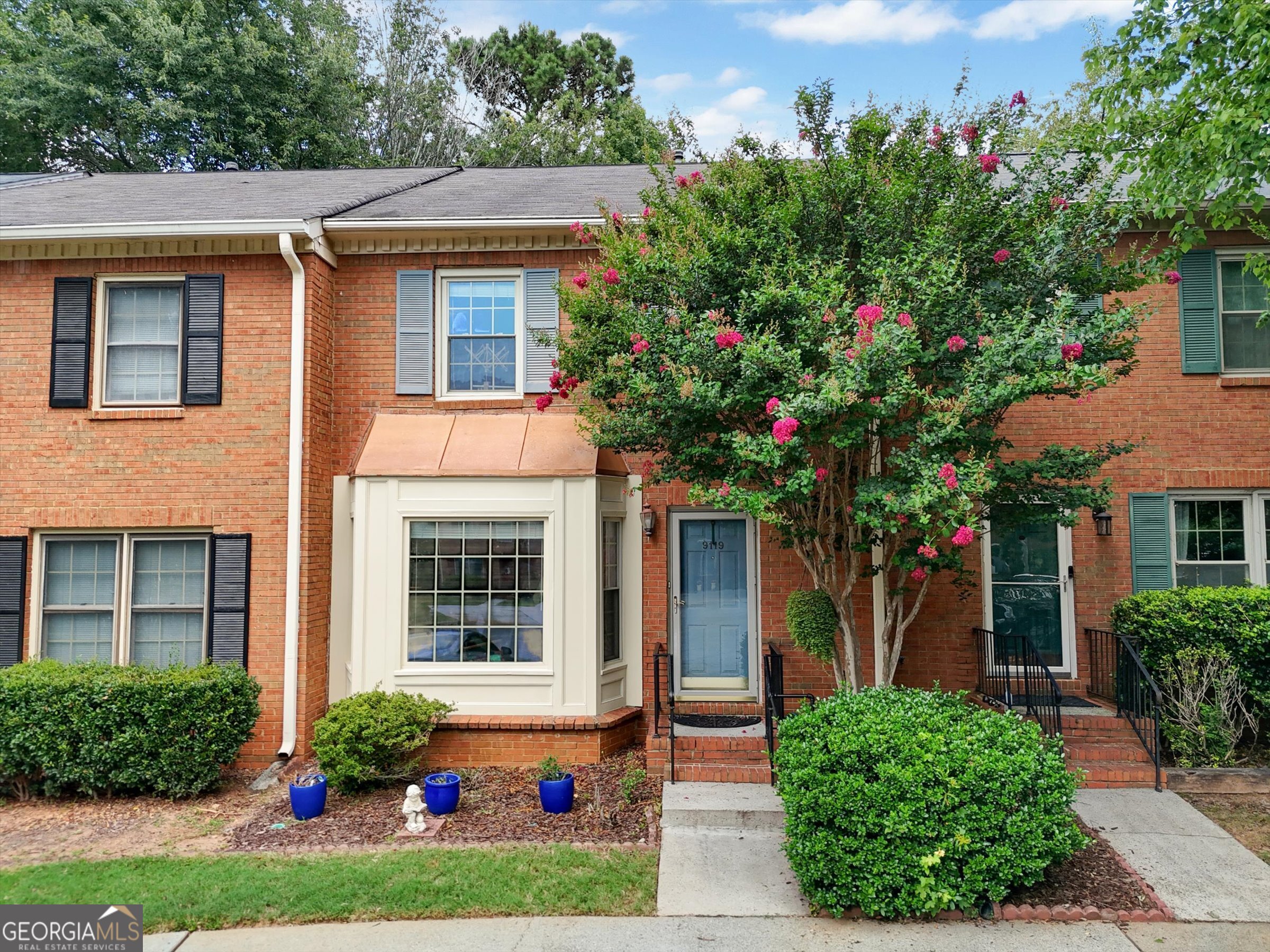 Beautifully Updated Townhome in Prime Roswell Location! Welcome to this well-maintained 4-sided brick townhome (more than 1700 sq. ft!) in a quiet community in desirable North Fulton. The main level showcases a dining room (great for an office or flex space), kitchen with silestone counters, large family room, and powder room. Dual en-suite bedrooms upstairs offer flexibility and comfort with the laundry conveniently nearby. Thoughtful updates include a gorgeous fireplace surround, a charming bay window, and energy-efficient vinyl windows. A brand new HVAC system ensures year-round comfort, while the custom primary closet adds organization. Enjoy the peaceful, tree-lined backyard from your private deck-a perfect extension of the living space. The home also offers great storage options and two assigned parking spaces. Located on a classic Roswell street just minutes from East Roswell Park with an array of offerings and events, and commuter routes. Just down the street: River Eves ES (a coveted STEM school) and Centennial HS. Only a few miles from hopping Historic Roswell with shopping, eateries, and events. An outstanding opportunity to own rather than rent with great investment potential.