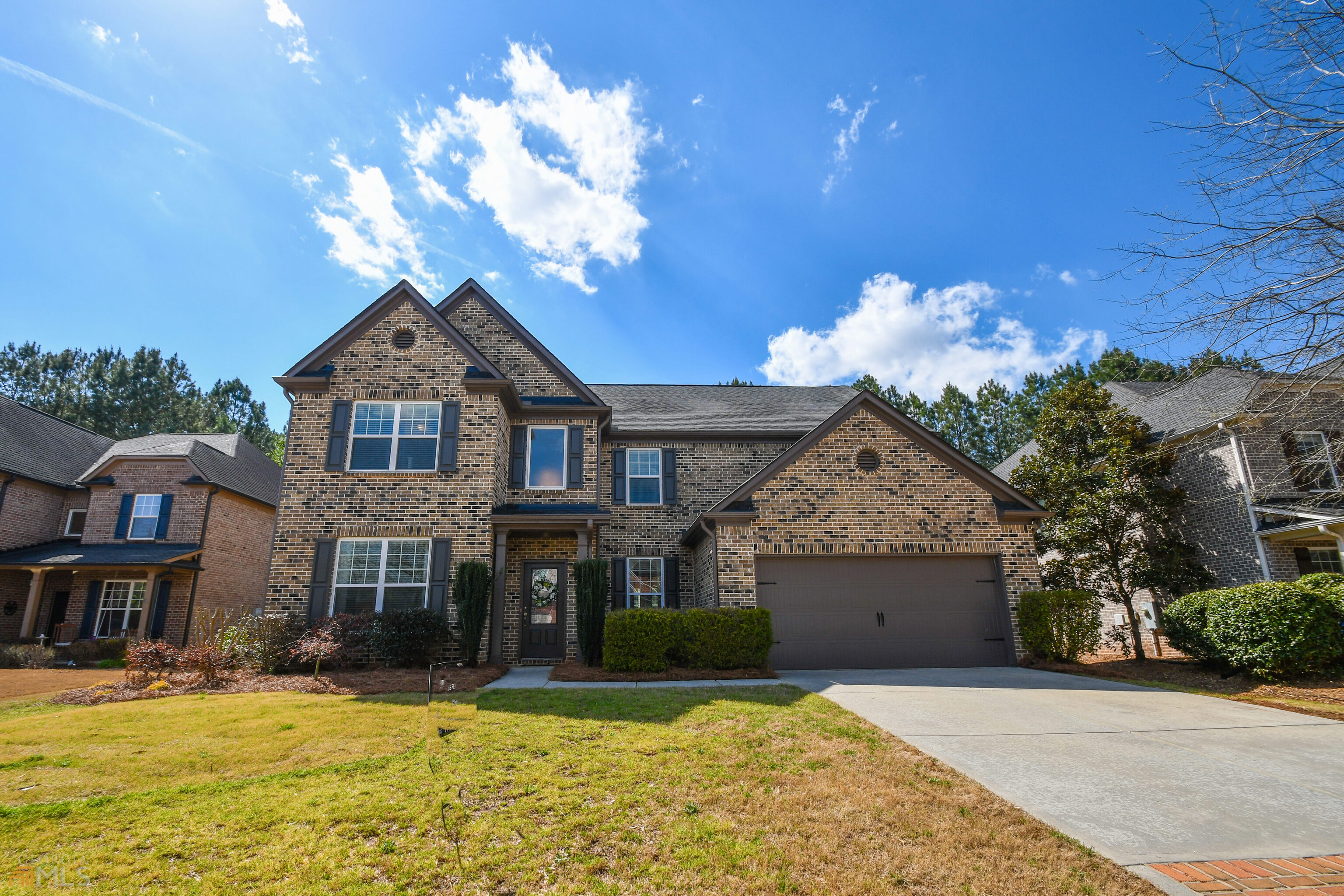 Beautiful 3 sided brick home with 5 bedrooms and 3 full baths. This home is perfect for the growing family. The open floorplan is every entertainers dream. Large eat in kitchen with Island and breakfast bar. Granite counter tops, SS appliances, tons of counter space and cabinets with a huge walk in pantry. Kitchen overlooks the large 2 story family room with custom built-in bookcase, fireplace and lots of natural light. Formal dining room and formal living/study. There's a Bedroom and full bath on the main level. Hardwood floors through out the main living area. Upstairs you will find the graciously sized master bedroom with a tray ceiling, large master bath with his and her vanities and a walk in closet. 3 additional spacious bedrooms upstairs as well as the laundry room. Great level fenced in back yard perfect for the kids and the pets. Professionally landscaped. LOCATION LACATION Highly sought after Forsyth county neighborhood located in South Forsyth convenient to Lake Lanier, GA 400, shopping and restaurants.