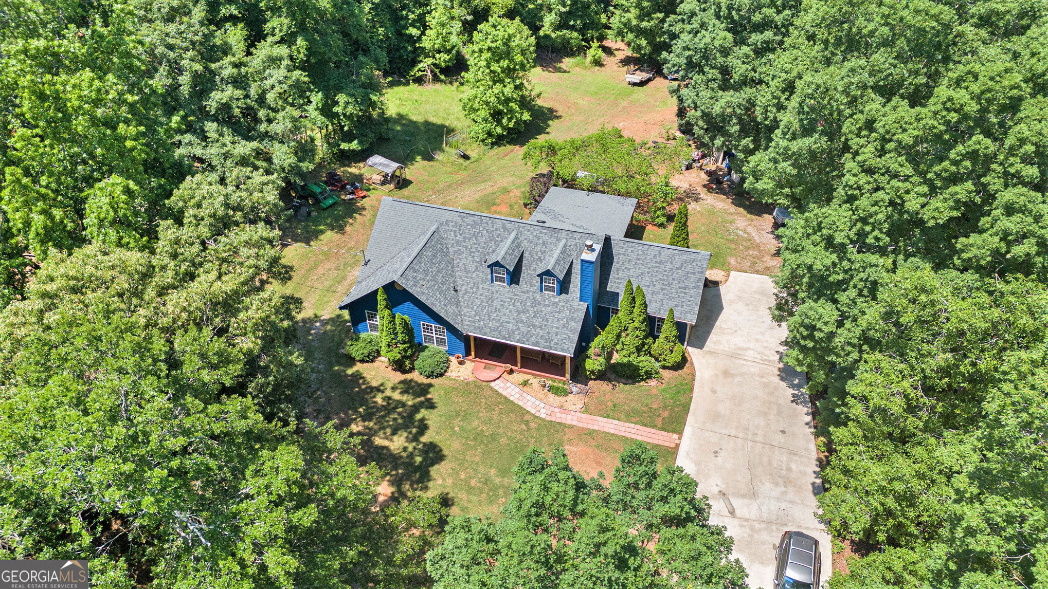 Welcome to a beautifully maintained 4-bedroom, 2.5-bathroom home situated on 5.19 private, picturesque acres in Griffin, GA. Designed for both comfort and function, this property is fully equipped and ready for horses, making it the perfect haven for equestrian enthusiasts or anyone craving a peaceful country lifestyle. Recent upgrades include a new roof, new Hardie Plank siding, fresh interior and exterior paint, a new Rheem AC system, granite countertops in the kitchen and bathrooms, and stainless steel appliances, offering modern comfort and long-term peace of mind. Step inside to discover a thoughtfully designed layout featuring spacious living areas and a custom kitchen ideal for cooking, entertaining, or gathering with family. Outside, the property shines with multiple outbuildings, including a horse stable, storage sheds, and fenced areas perfect for your animals. The back of the property features serene walking and riding trails, offering a tranquil setting for trail rides, nature walks, or quiet reflection. Enjoy a peaceful setting just minutes from downtown Griffin. Whether you're looking for a move-in ready mini-farm, a family homestead, or a weekend getaway, this property delivers the space, functionality, and charm you've been searching for. Schedule your private tour today and make 235 Cecil Jackson Rd your next home!