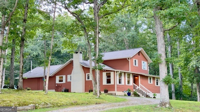 Fantastic opportunity with UNRESTRICTED 6.84 acres with a FULLY REMODELED home, WORKSHOP WITH OFFICE, and BARN. *Mini-farm *Commercial property *Family compound *endless opportunities! *This character-rich house has 4 bedrooms, 3.5 baths, an open concept living space, and a large primary suite on the main level! This beautiful home was remodeled with much love and detail. It blends charm with modern design touches, all set in a peaceful, private location. The heart of the home is the beautiful custom kitchen, open living and dining area, and a large family room offering even more space to retreat to. The luxurious primary suite, with French doors that open directly to the back porch, is a true spa-like escape with a modern walk-in shower, a beautiful soaking tub, a custom hickory double vanity, and modern shiplap accents. Upstairs has two bedrooms and a remodeled bathroom. Downstairs, a newly finished basement adds function, featuring a 4th bedroom with private patio, a brand-new bathroom, and a comfortable living space-ideal for guests, a home office, or multi-generational living. Tucked beneath mature trees, the home stays shaded and cool through summer, and opens up with natural light during the bright fall and winter months. The WORKSHOP has three tall roll-up doors with concrete flooring, a carport, and an additional barn loft. Garden area- in-ground and raised beds. Conveniently located between Blairsville and Blue Ridge. 3 min. to a boat ramp on Nottely Lake. The house is currently on city water, and a private well on the property is available. Wood-burning stove in family room, wood-burning fireplace has gas logs in living room. The neighboring property has horses and cows. Rooster and 4 hens can be sold with house.Listing Agent is owner.
