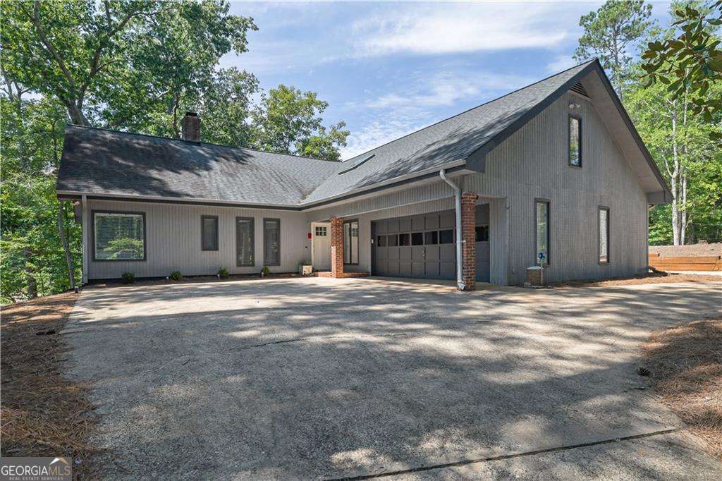 Lakefront Living in Sought-After Lake Arrowhead! Welcome to this beautifully updated 3-bedroom, 2-bath ranch-style home, perfectly positioned on the shores of Lake Arrowhead with over 50 feet of private lake frontage and your own dock ideal for boating, fishing, or simply relaxing lakeside. Inside, you'll find bamboo hardwoods throughout, a spacious living room with a wood-burning fireplace and vaulted ceilings, and a stunning kitchen featuring quartz countertops, rich stained cabinetry, and stainless steel appliances. The separate dining room is perfect for entertaining. Retreat to the lakeview primary suite, complete with a spa-like bathroom offering a double vanity, walk-in tile shower, soaking tub, tile floors, and a generous walk-in closet. Step outside to a large back deck overlooking the water your personal oasis for morning coffee or evening sunsets. Additional features include a tankless water heater and a roof replaced in 2019. Strong rental potential, located in Phase 1 of Lake Arrowhead Community which is the only section that allows short-term rentals. Lake Arrowhead is a gated community that offers 24-hr security, two swimming pools, parks, walking trails, a clubhouse, an 18-hole Golf Course, restaurant, chapel & Marina. This home offers luxury lakefront living with modern updates, natural beauty, and unmatched tranquility.