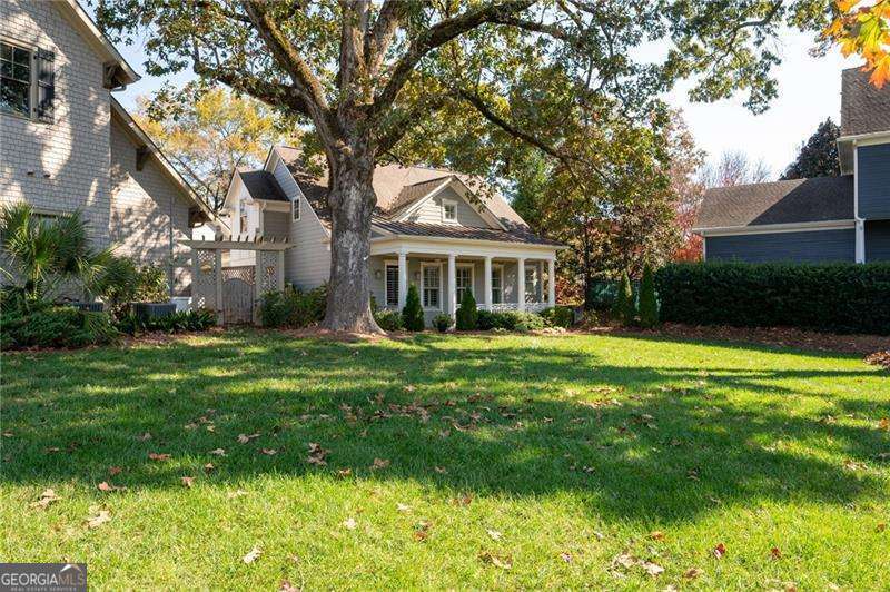 Welcome to this quaint, stunning craftsman cottage in downtown Woodstock. Tucked away in a cozy little neighborhood between downtown Woodstock and the Outlet Mall, this home is walkable and golf cart accessible to shopping, dining and entertainment. Enjoy all that downtown Woodstock has to offer. Conveniently located, with easy access to 575 and Towne Lake Parkway. This home boasts four bedrooms 3 1/2 baths, a two car garage and storage galore with three walk-in attics. It has a beautiful relaxing fenced courtyard and a rare master on the main. The open floor plan is perfect for entertaining. The top floor of your new home hosts two large secondary bedrooms, a full bathroom and a large loft. There is a separate bedroom and bath over the garage with an outside access door, perfect for an office or an apartment. Home in Sought-After Woodstock Downtown-Money Magazine voted Top 50th Town to Live!!! Home is walkable to the best Restaurants, City Parks, Greenprint Trails, Boutiques Shopping, Farmers Market, Elm Street Arts, New Amphitheater and MUCH MORE!!! The seller is fully aware that on-street parking can be challenging in Mill Park as Woodstock grows. Seller is offering a $2,000 (estimated cost) concession to the Buyer for the installation of a paved parking pad that will allow for 2 parking spaces in addition to the 2 car garage. Parking problem solved!